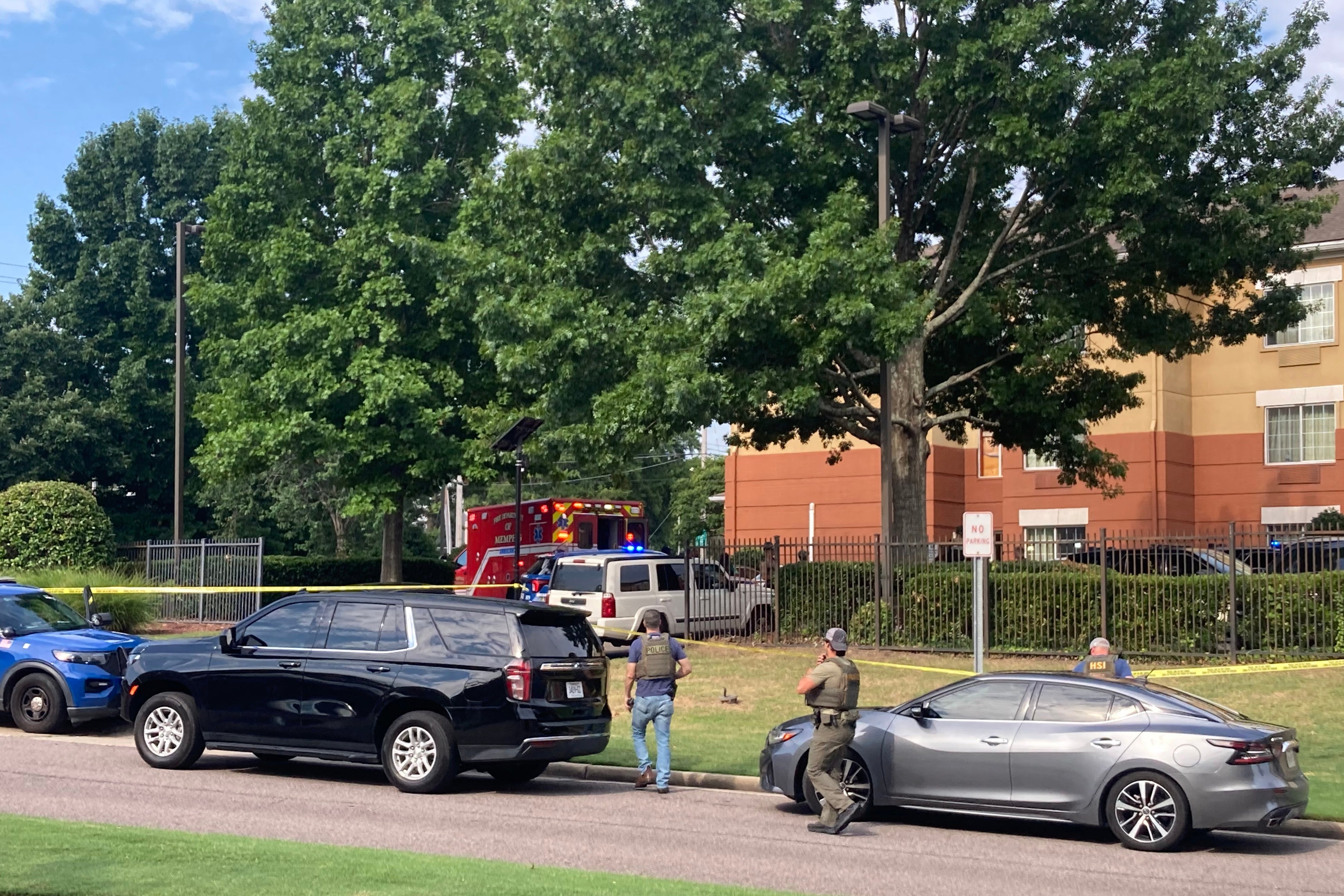 Law enforcement officers work the scene after a federal agent with the Memphis Safe Task Force shot and killed a person at a hotel in Memphis