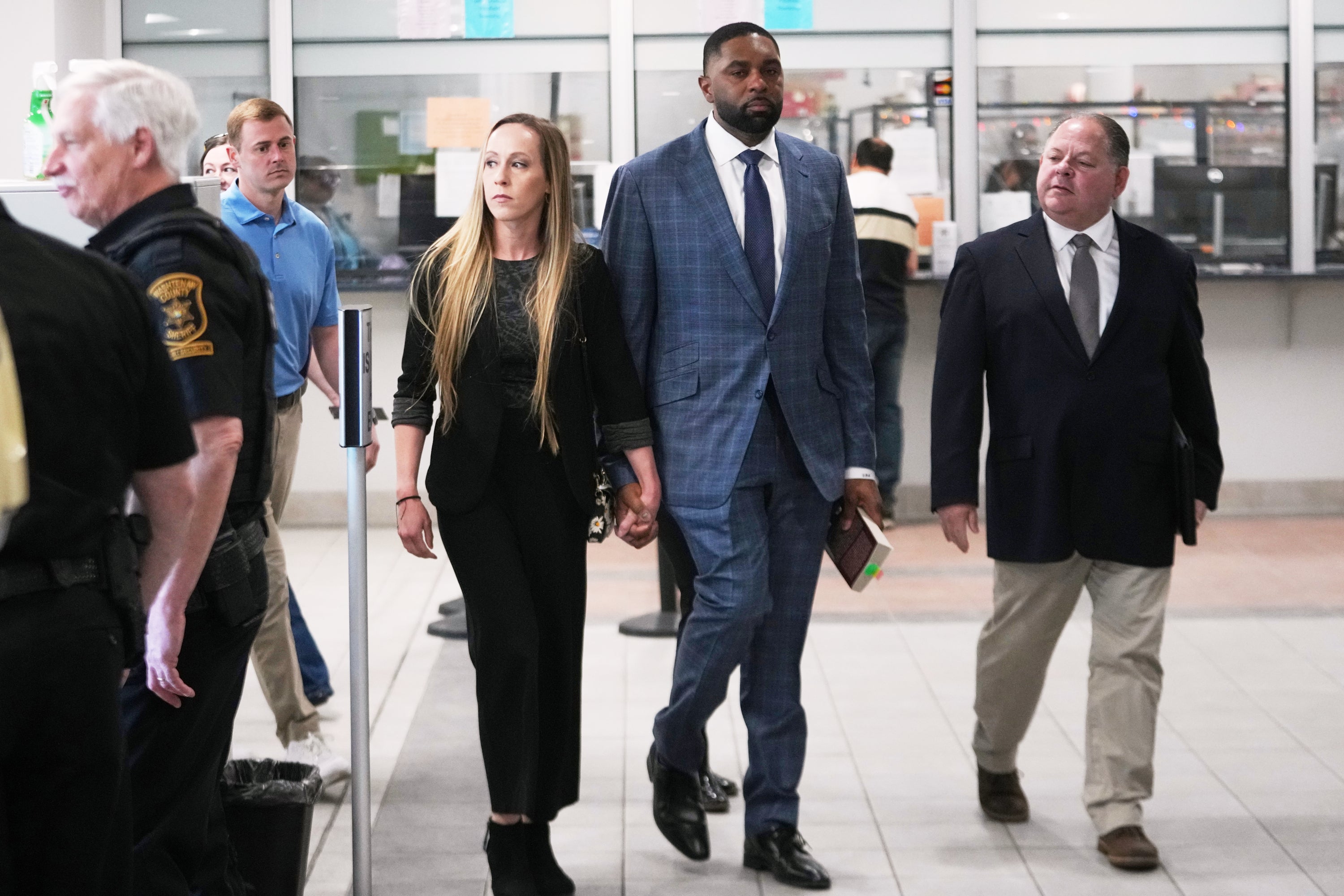 Former Michigan football coach Sherrone Moore and his wife Kelli Moore leave court, April 14, 2026, in Ann Arbor (Copyright 2026 The Associated Press. All rights reserved)