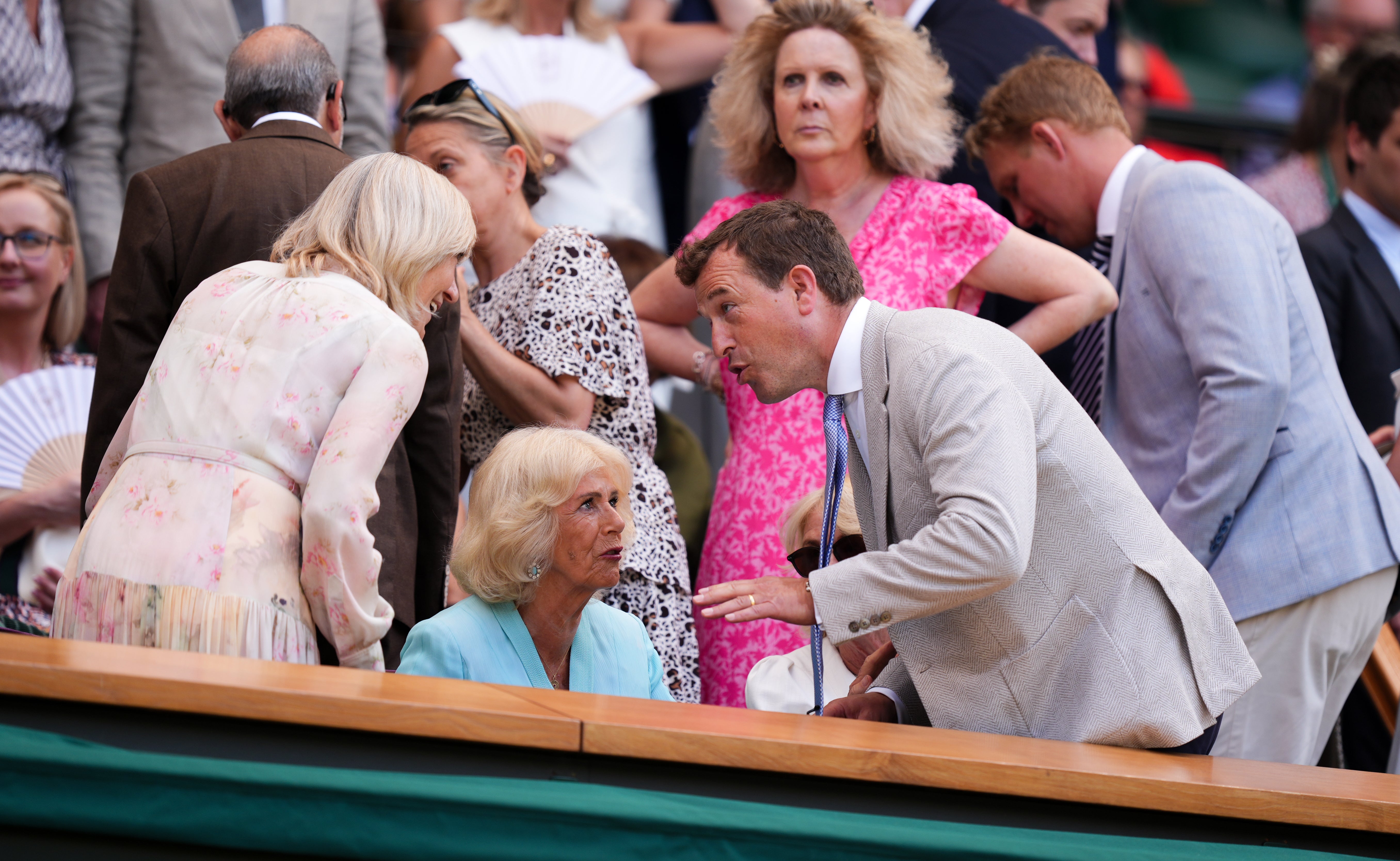 Queen Camilla speaks with Peter Phillips and Deborah Jevans in the royal box