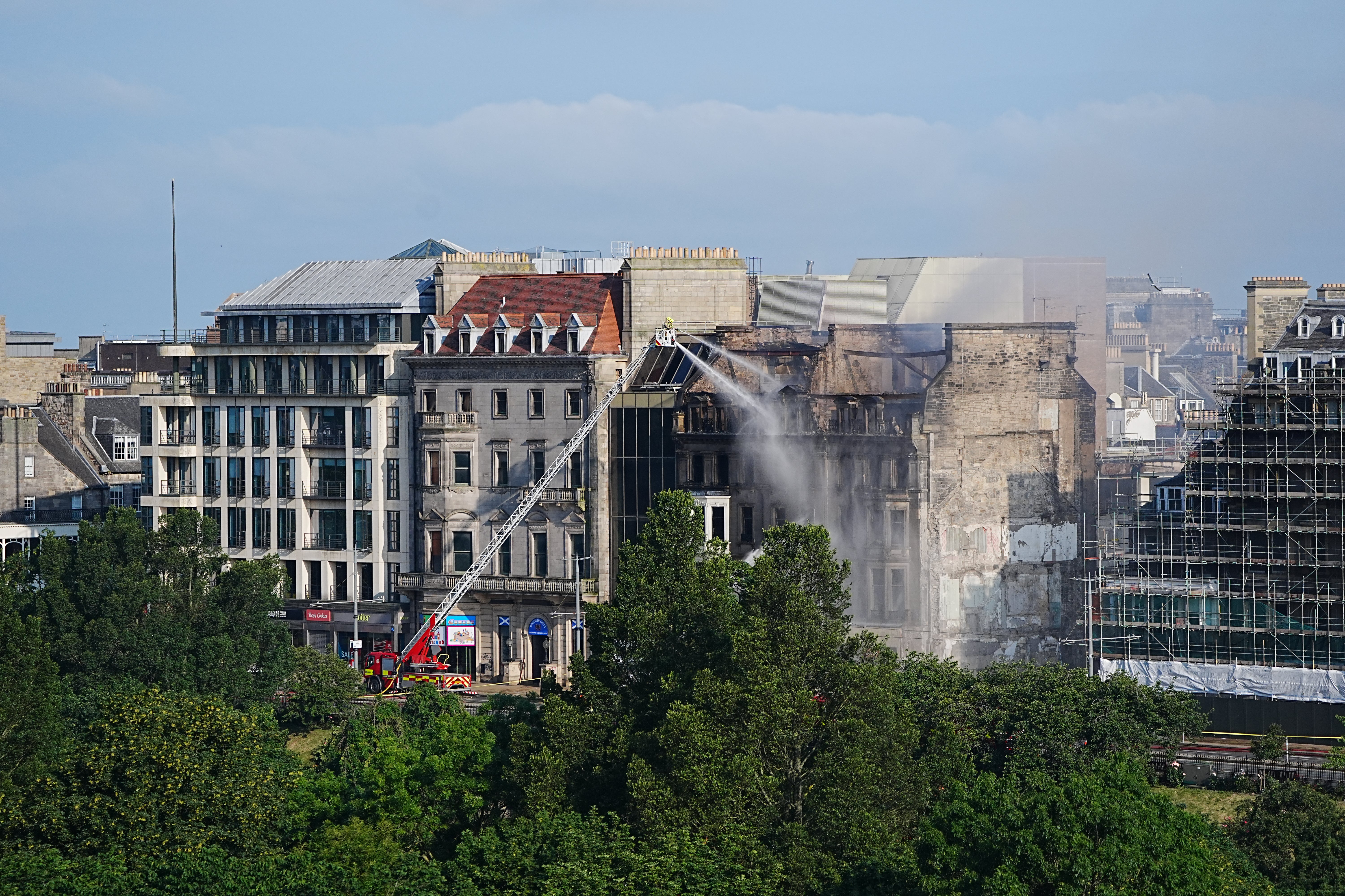 The roof and top floors of the disused B-listed building have been destroyed by the blaze (PA)