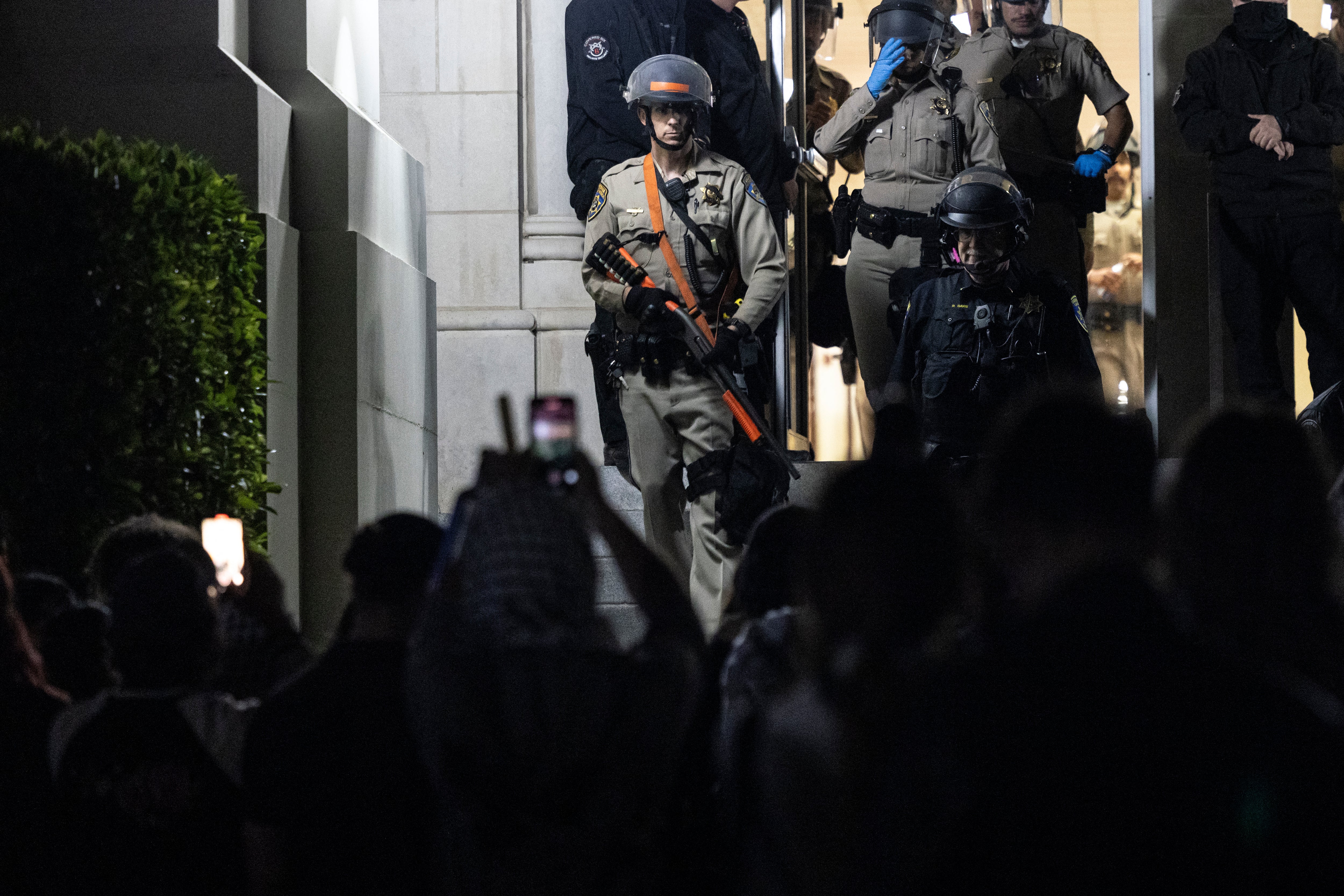 University of California Police and California Highway Patrol officers face pro-Palestinian protesters outside Dodd Hall in the University of California at Los Angeles (UCLA) in Los Angeles, June 10, 2024