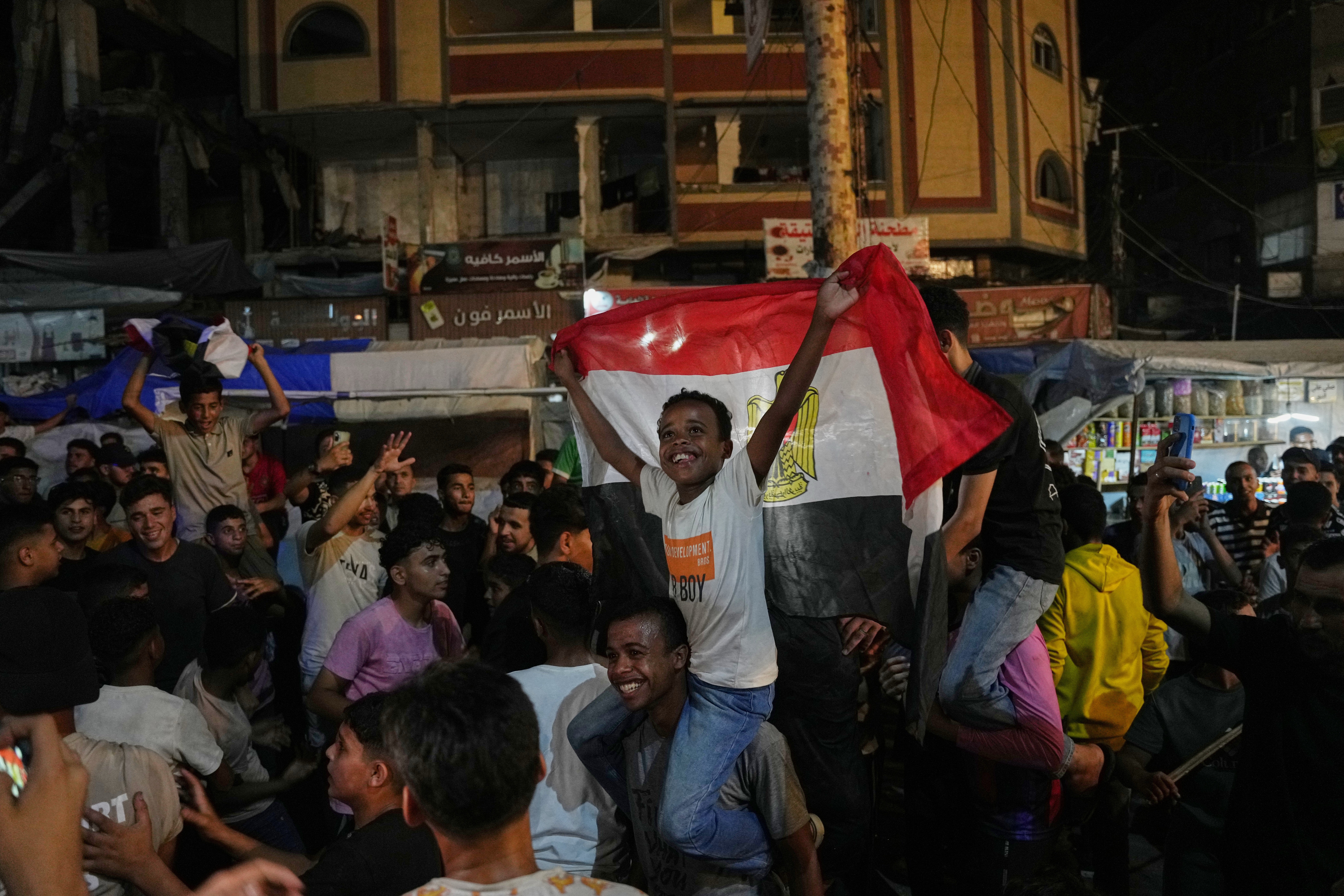 Palestinians react as they watch a live broadcast of the World Cup round of 32 soccer match between Egypt and Australia in Nuseirat, central Gaza Strip, Friday, July 3, 2026. (AP Photo/Abdel Kareem Hana)