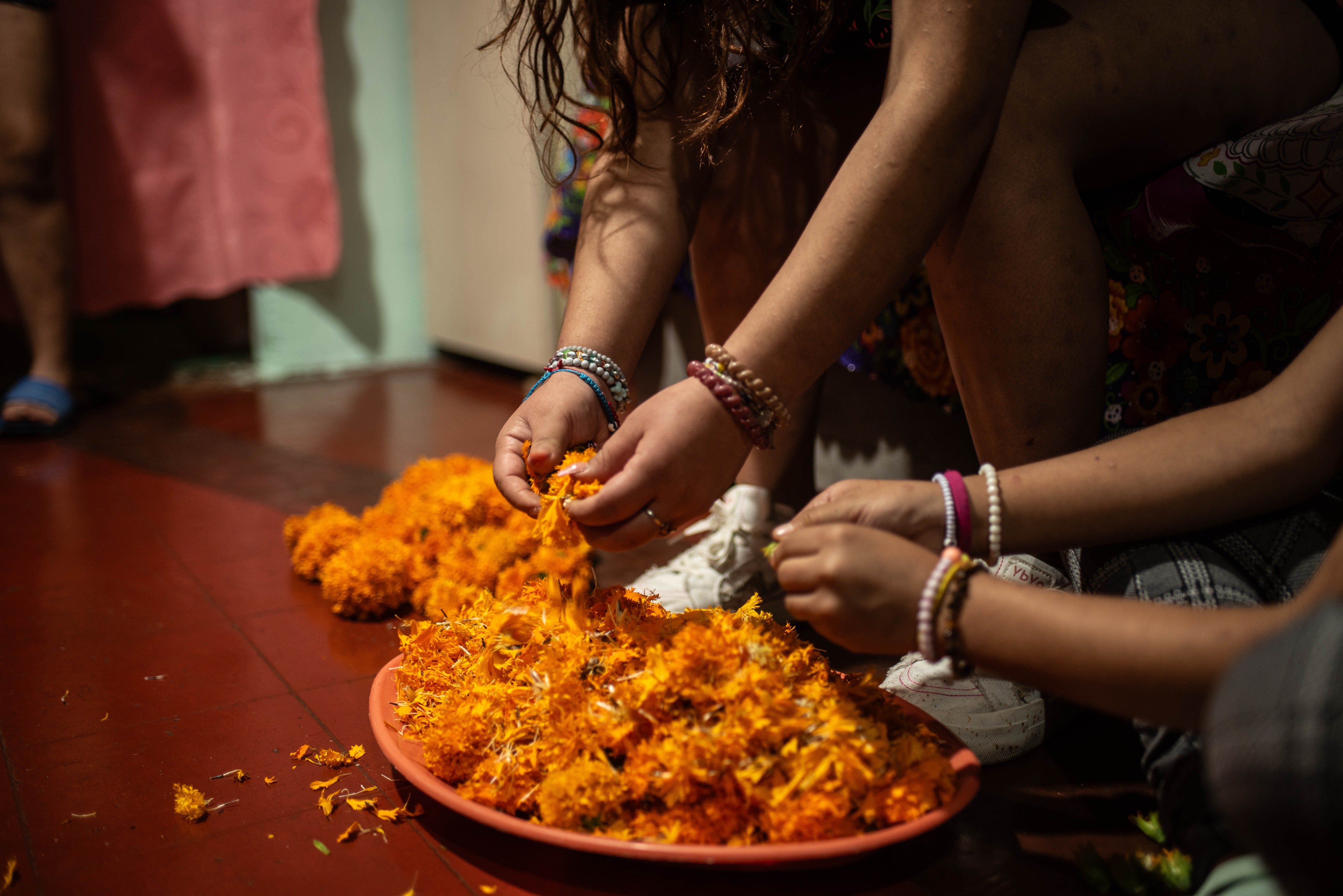 Two women remove the petals from marigold flowers for a Day of the Dead offering in Veracruz, Mexico. New research touts the protein benefits of the marigold