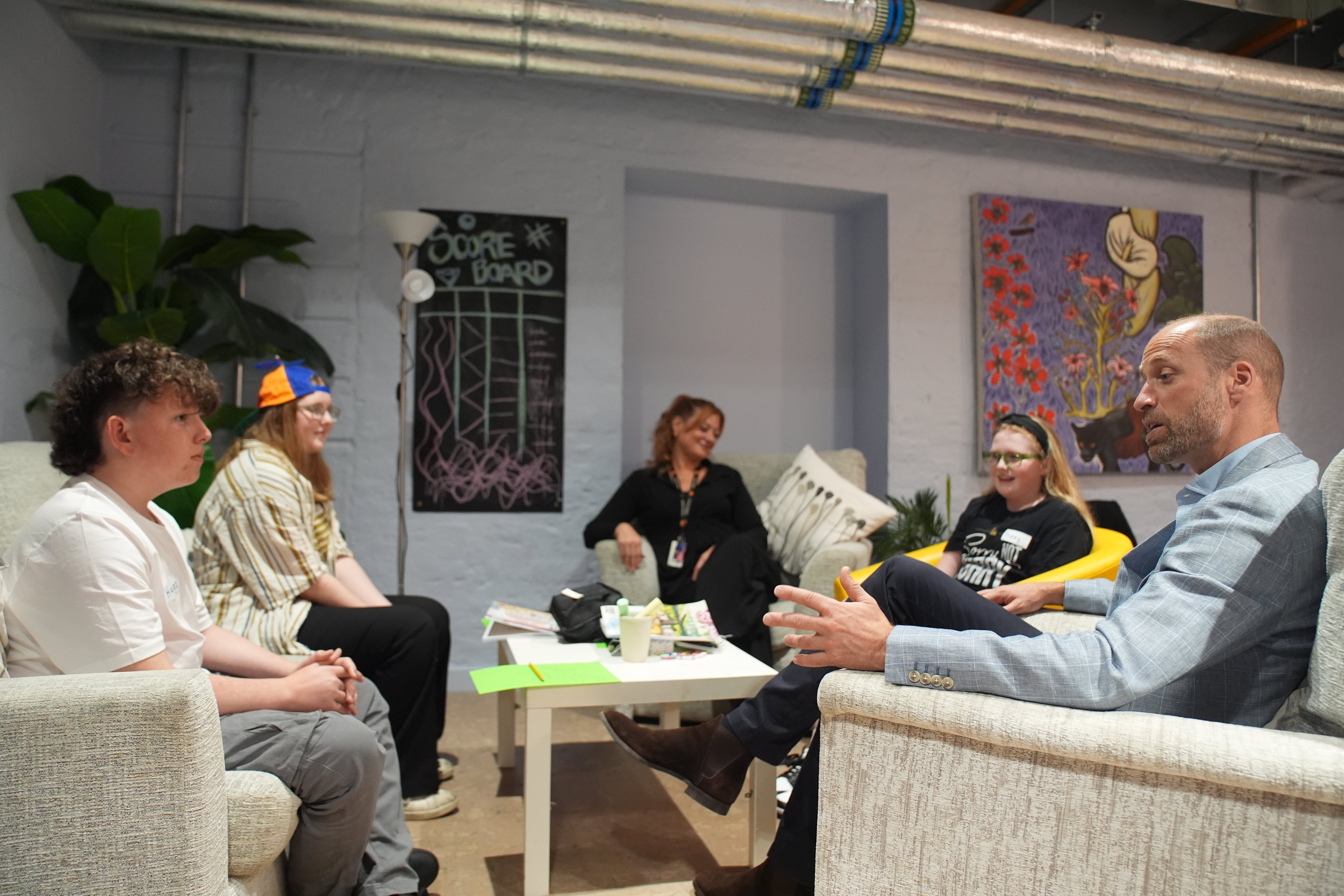 William meets young people and volunteers in the Common Room at Eagle House, which functions as a ‘Public Living Room’ (Gareth Fuller/PA)