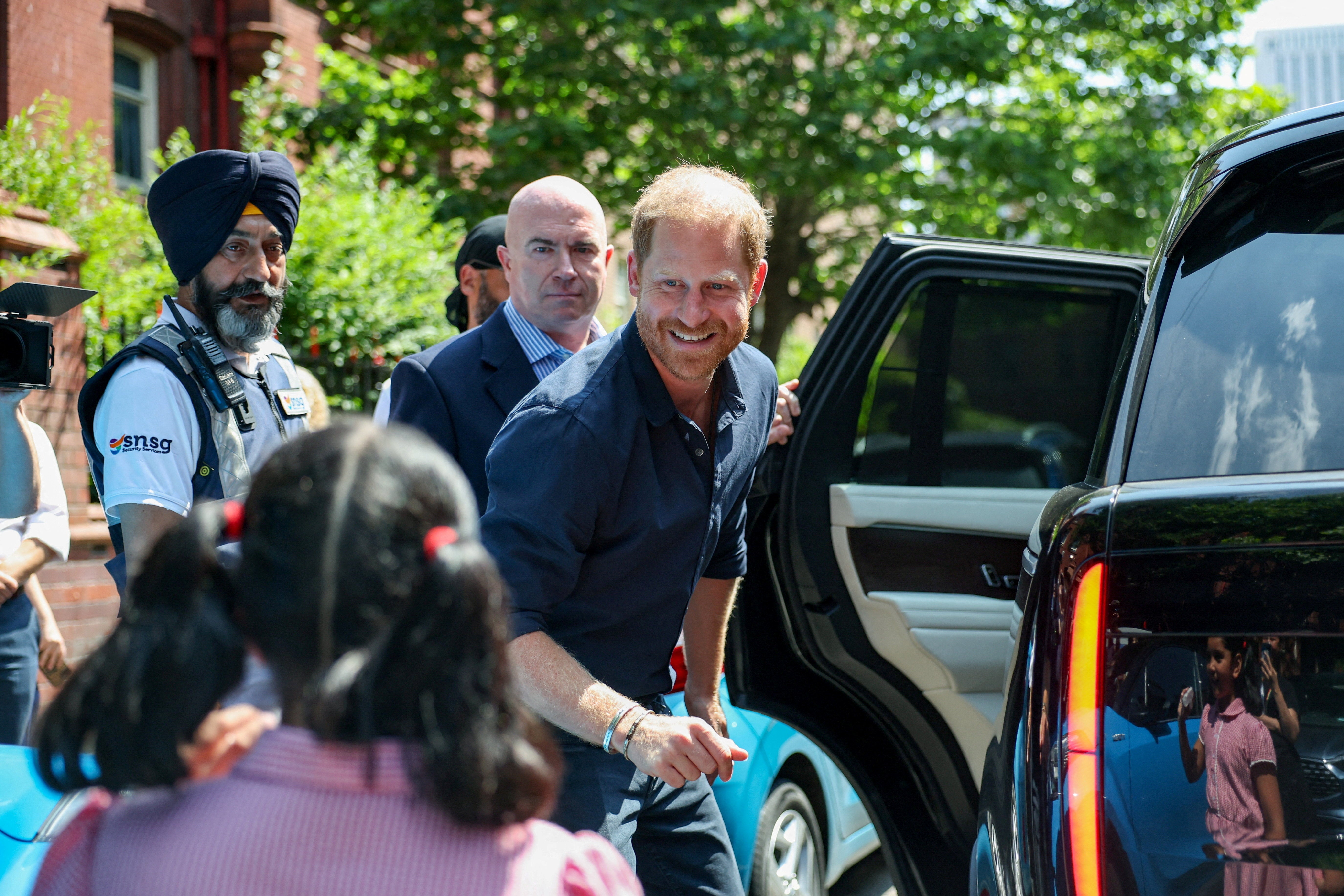 Britain's Prince Harry greets a child as he leaves the Birmingham Children's Hospital after celebrating the 20th anniversary of the first WellChild Nurse programme, in Birmingham, Britain, July 9, 2026