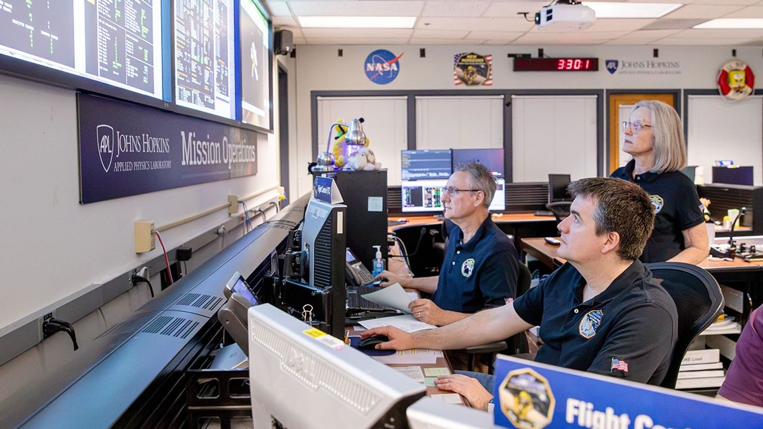 From left, flight controllers Mark Lahr and Josh Albers, and Mission Operations Manager Alice Bowman, monitor telemetry streaming from NASA's New Horizons spacecraft at the Johns Hopkins Applied Physics Laboratory in Maryland last month