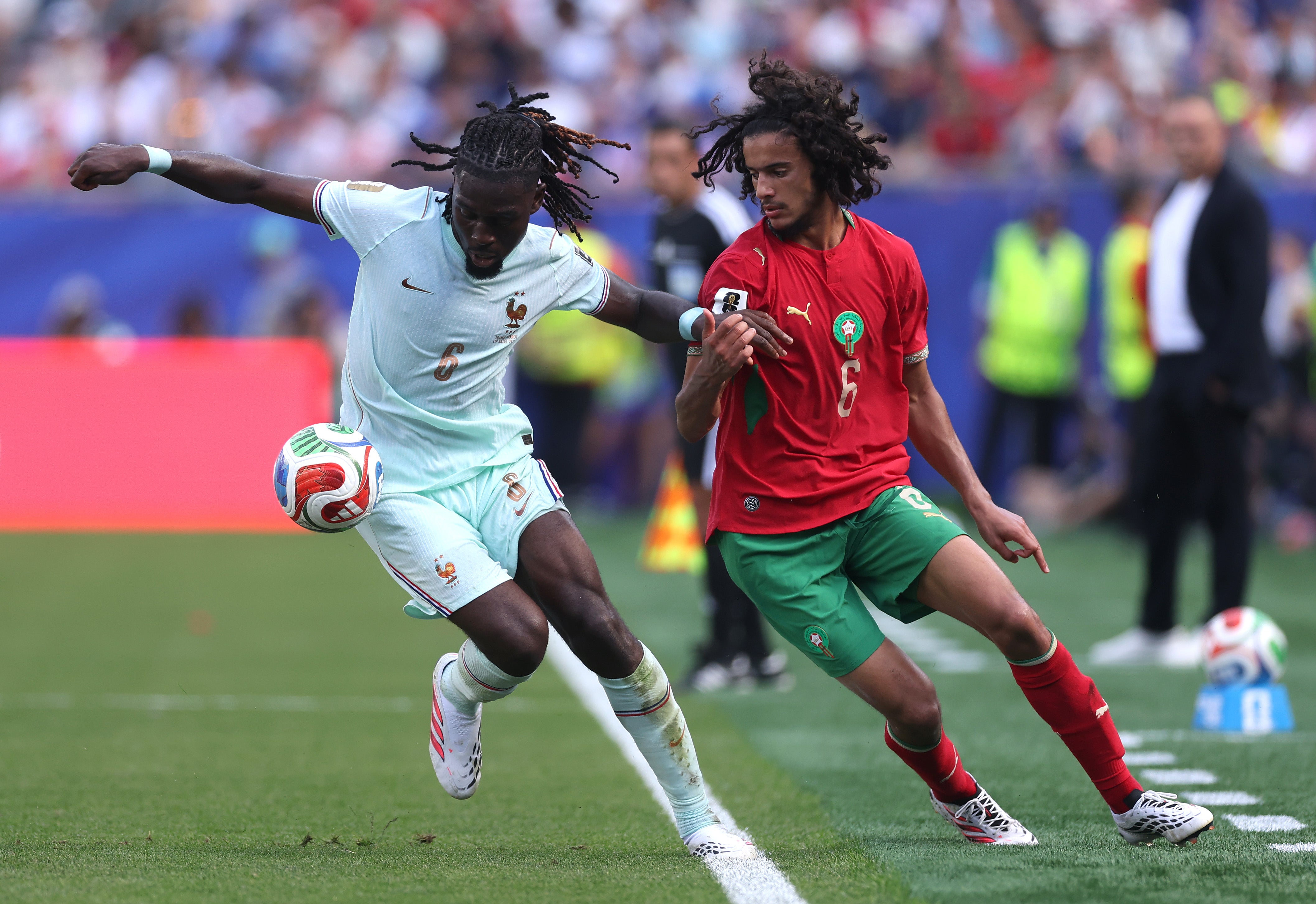 Ayyoub Bouaddi is held off by Manu Kone