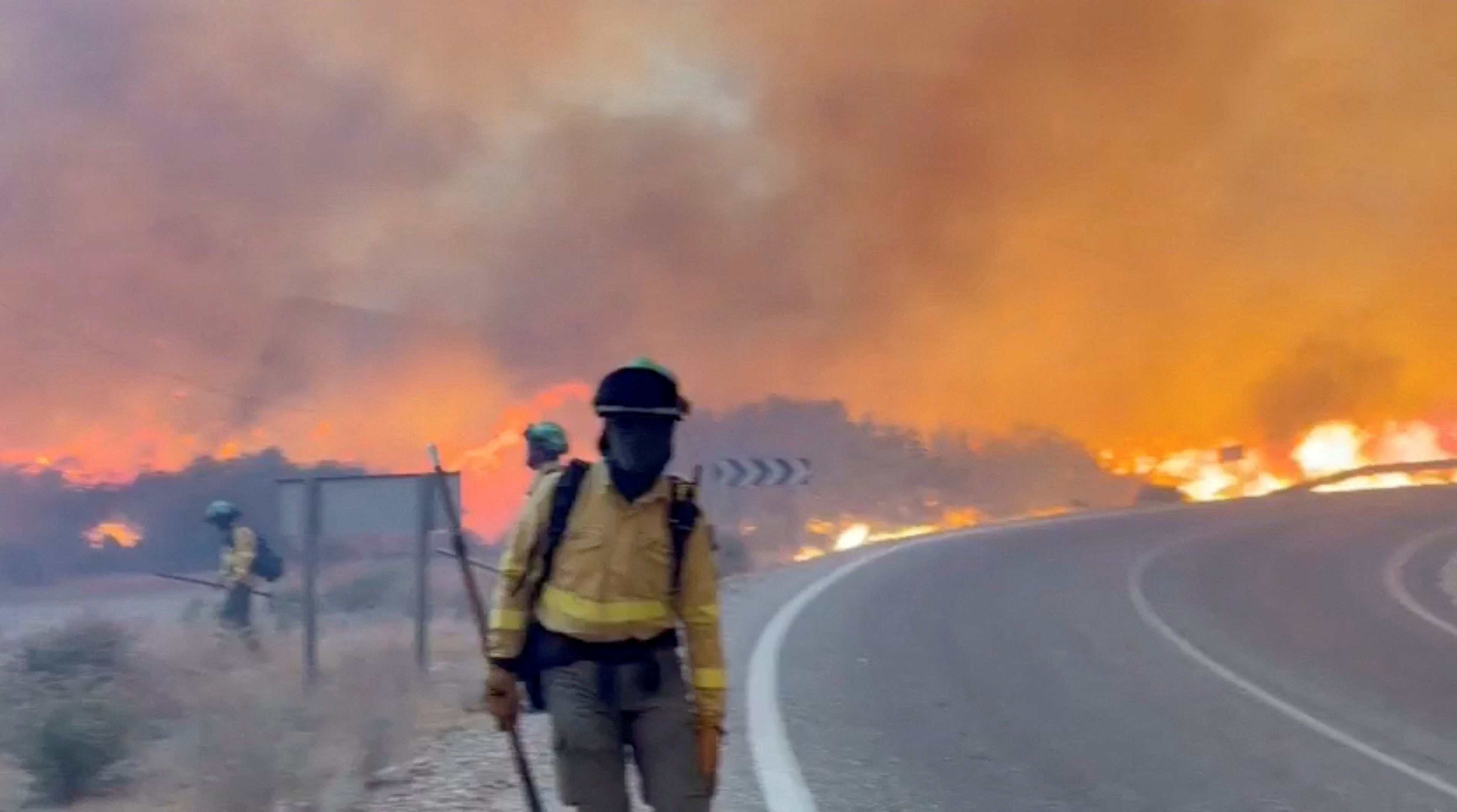 Emergency personnel work during a wildfire in Almeria in a picture released on Friday