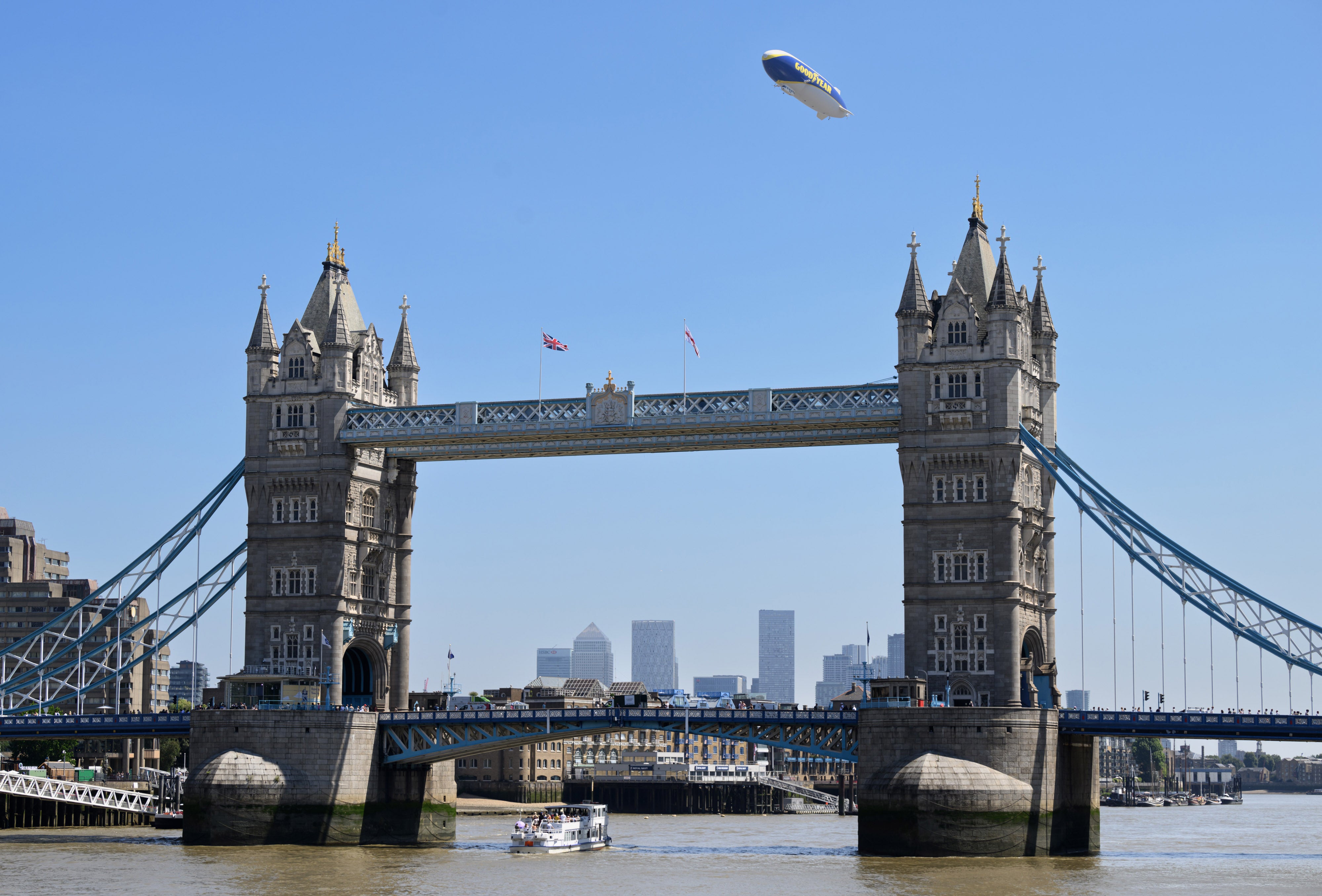 The Goodyear Blimp flying over Tower Bridge in London.