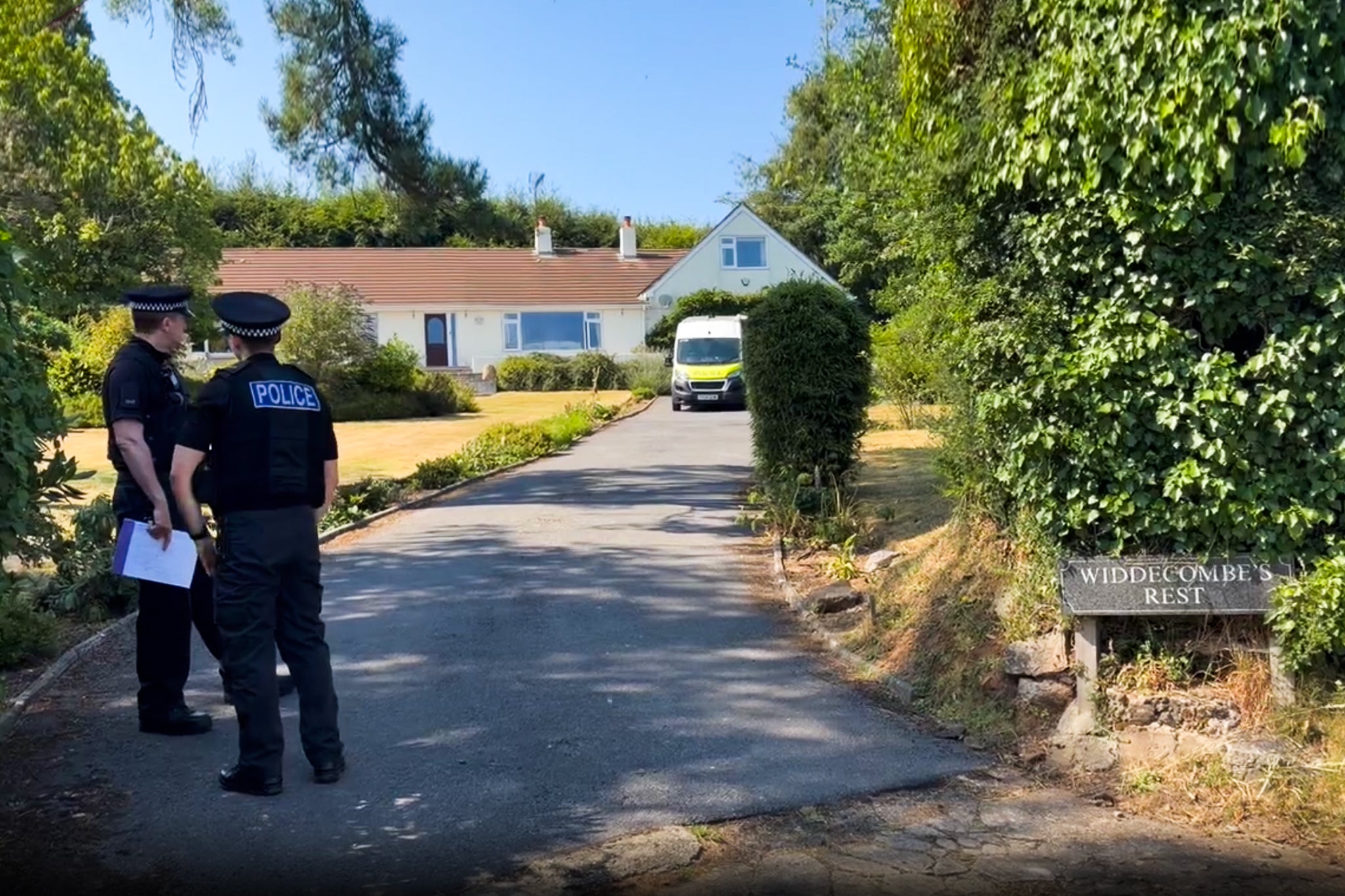 Police outside her home in the idyllic village of Haytor, Devon