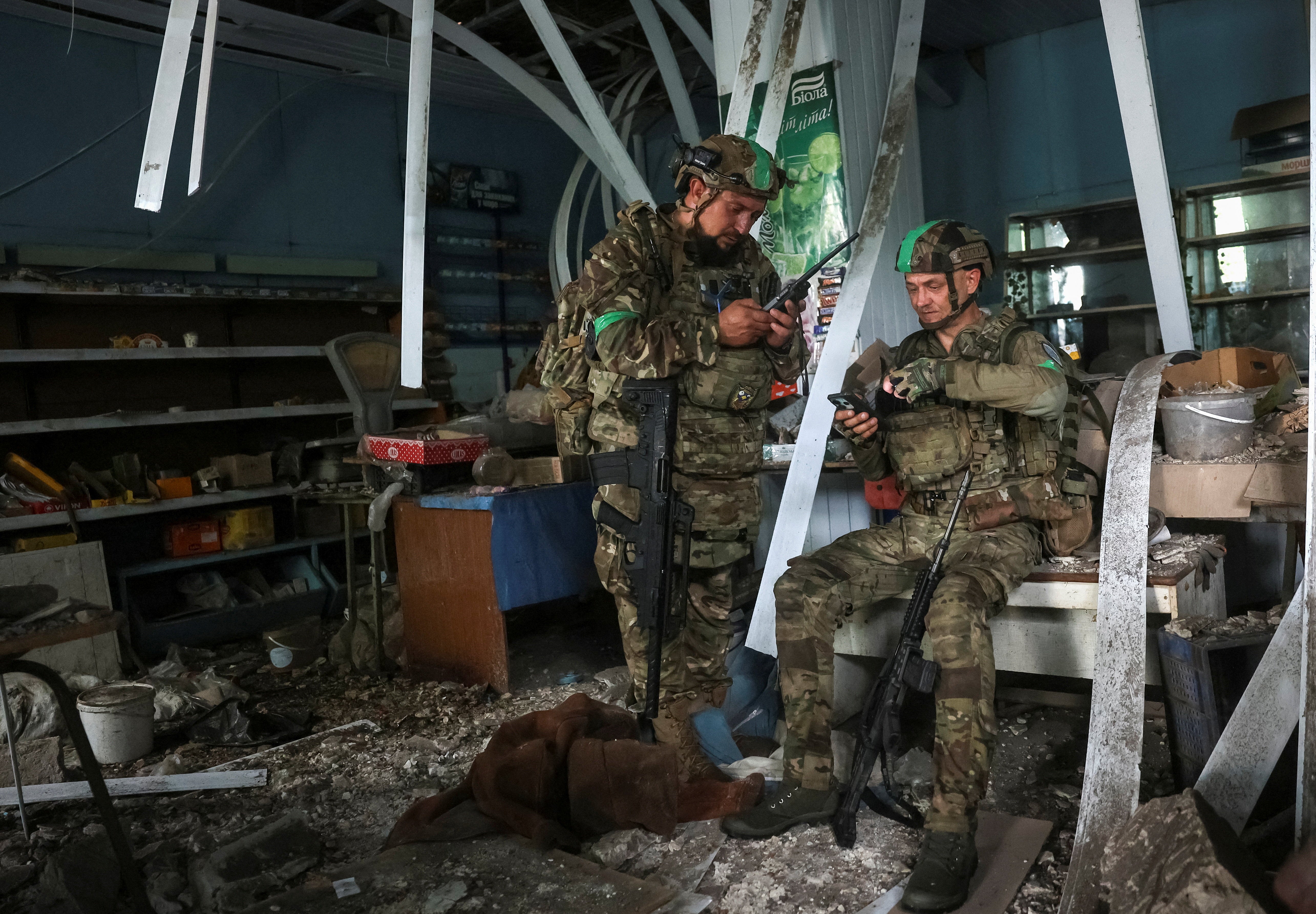 Servicemen of the 49th Separate Assault Battalion Carpathian Sich of the Ukrainian Armed Forces use a drone detector as they hide inside a damaged store during their combat mission, amid Russia's attack on Ukraine, in the frontline town of Druzhkivka, in Donetsk region, Ukraine July 9, 2026.