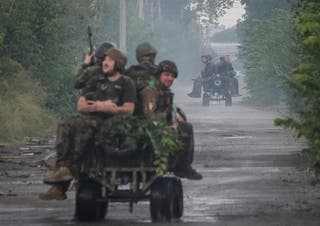 Ukrainian servicemen ride unmanned ground vehicles (UGV) during their combat mission, amid Russia's attack on Ukraine, in the frontline town of Druzhkivka, in Donetsk region, Ukraine July 9, 2026.