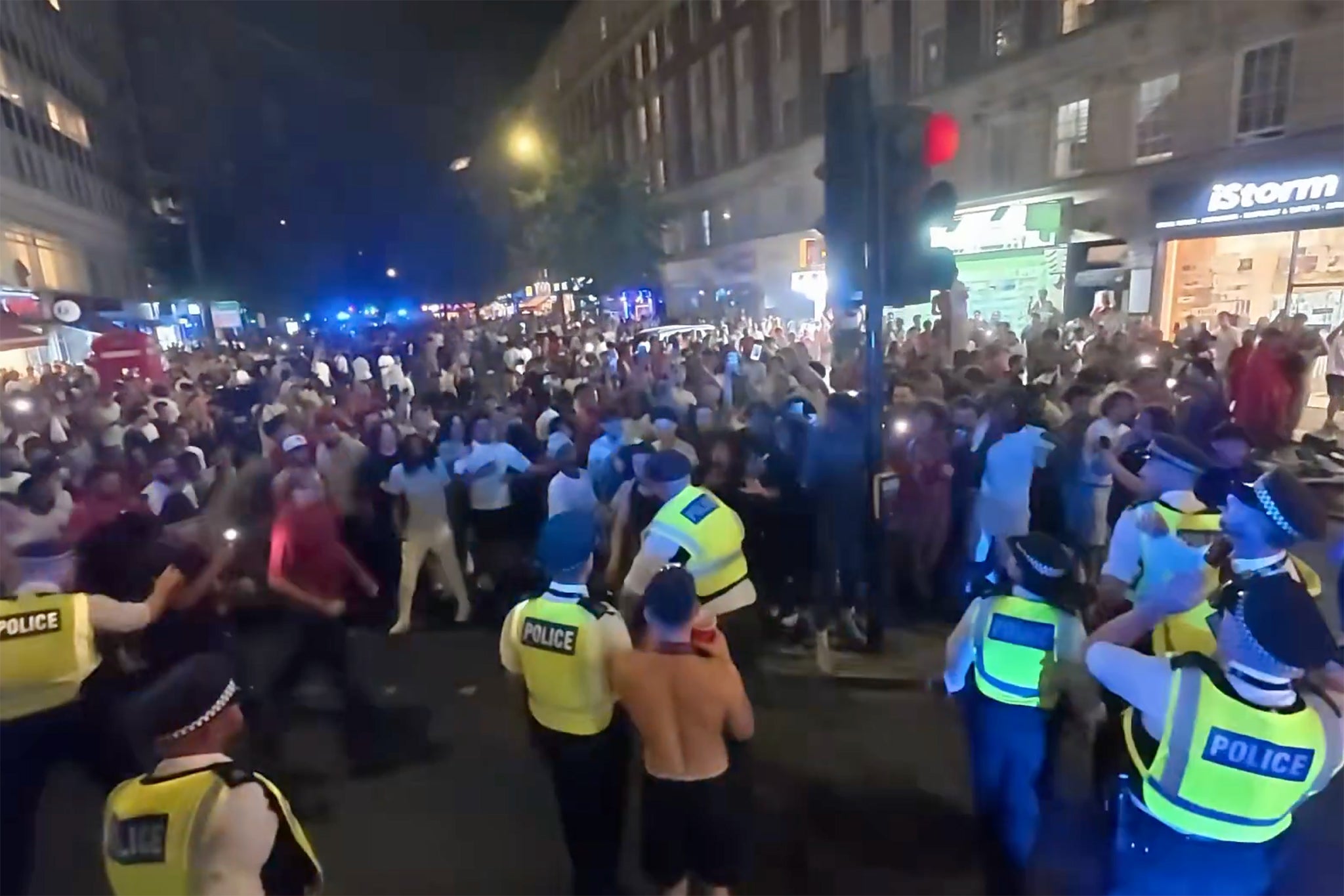 Video footage shows large crowds in the road as police held rioters back