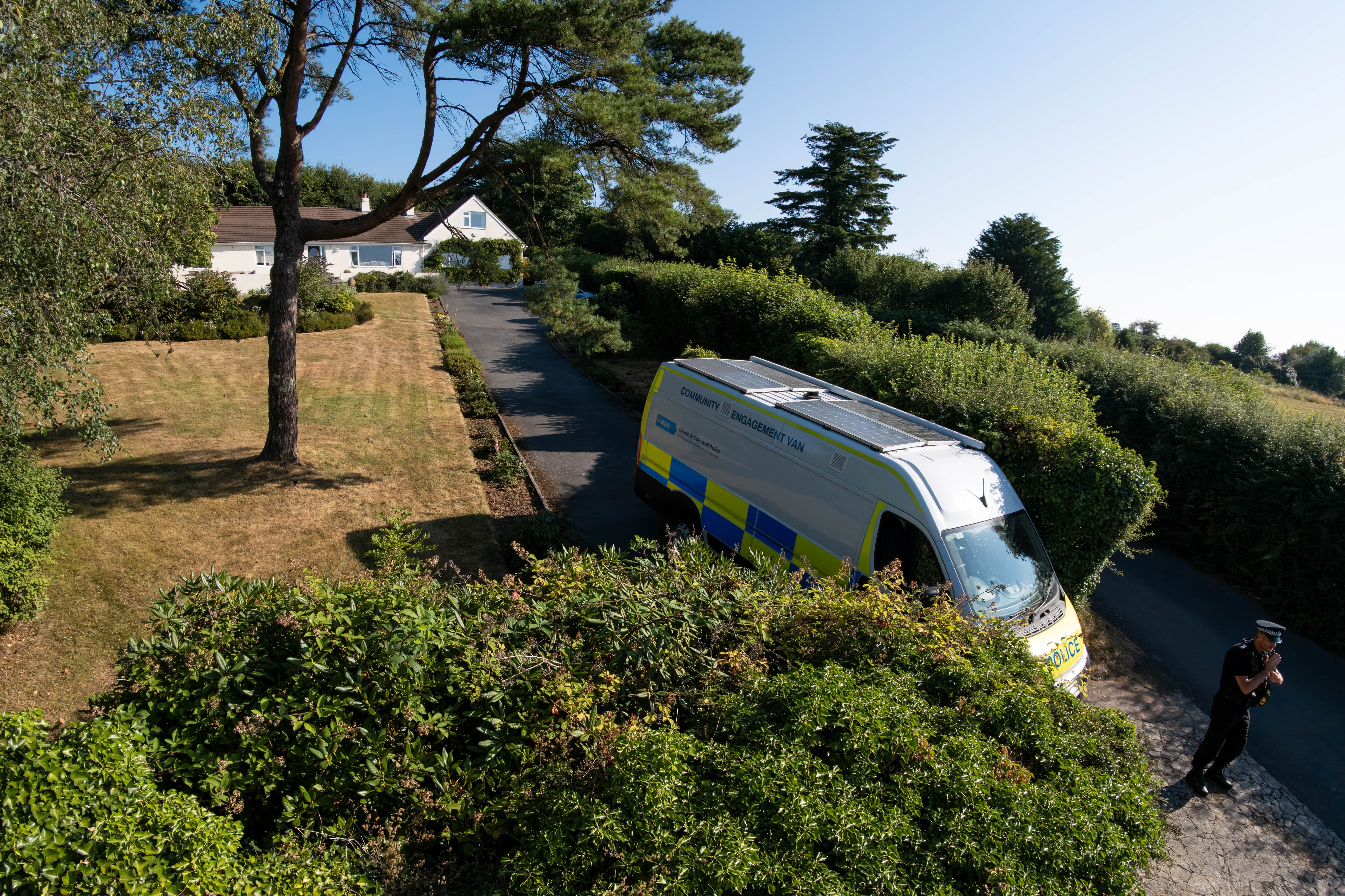 A police officer stands outside the house of Ann Widdecombe in Haytor on Saturday