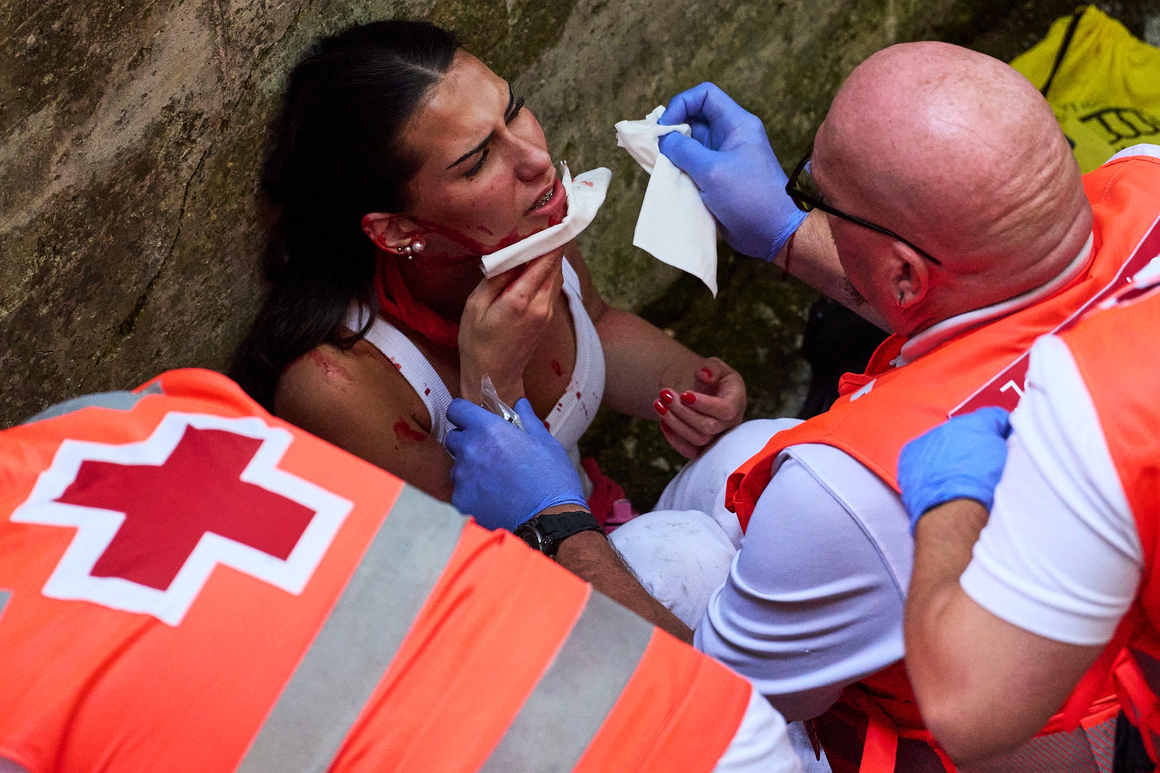 Doctors work on someone injured at the running of the bulls