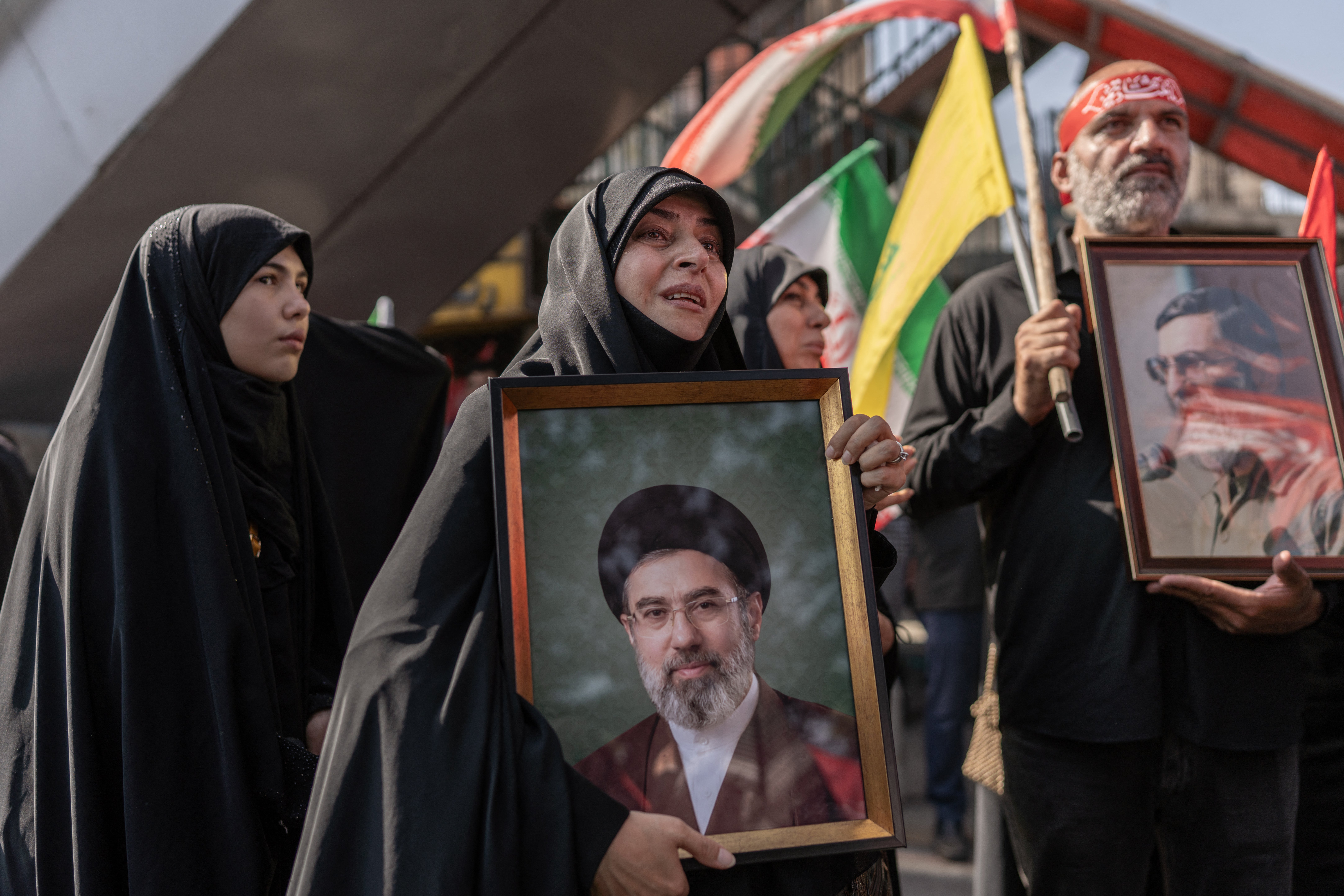 A mourner holds a portrait of Iran's new supreme leader Ayatollah Mojtaba Khamenei as people attend the funeral pocession of Iran's slain supreme leader Ayatollah Ali Khamenei and his family members in Tehran (AFP/Getty)