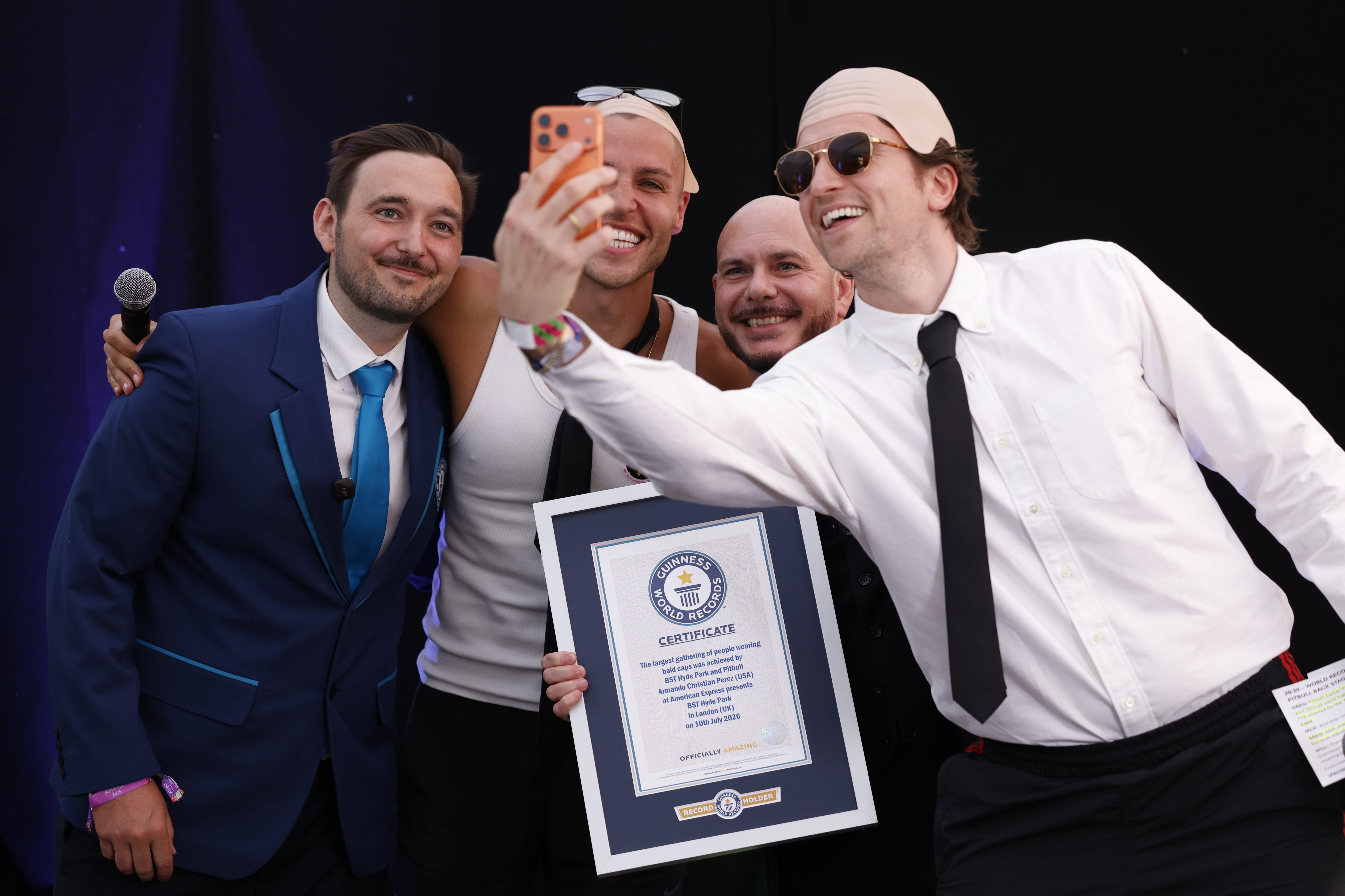 Greg James with Pitbull after he was presented with a Guinness World Record certificate (David Parry/PA)
