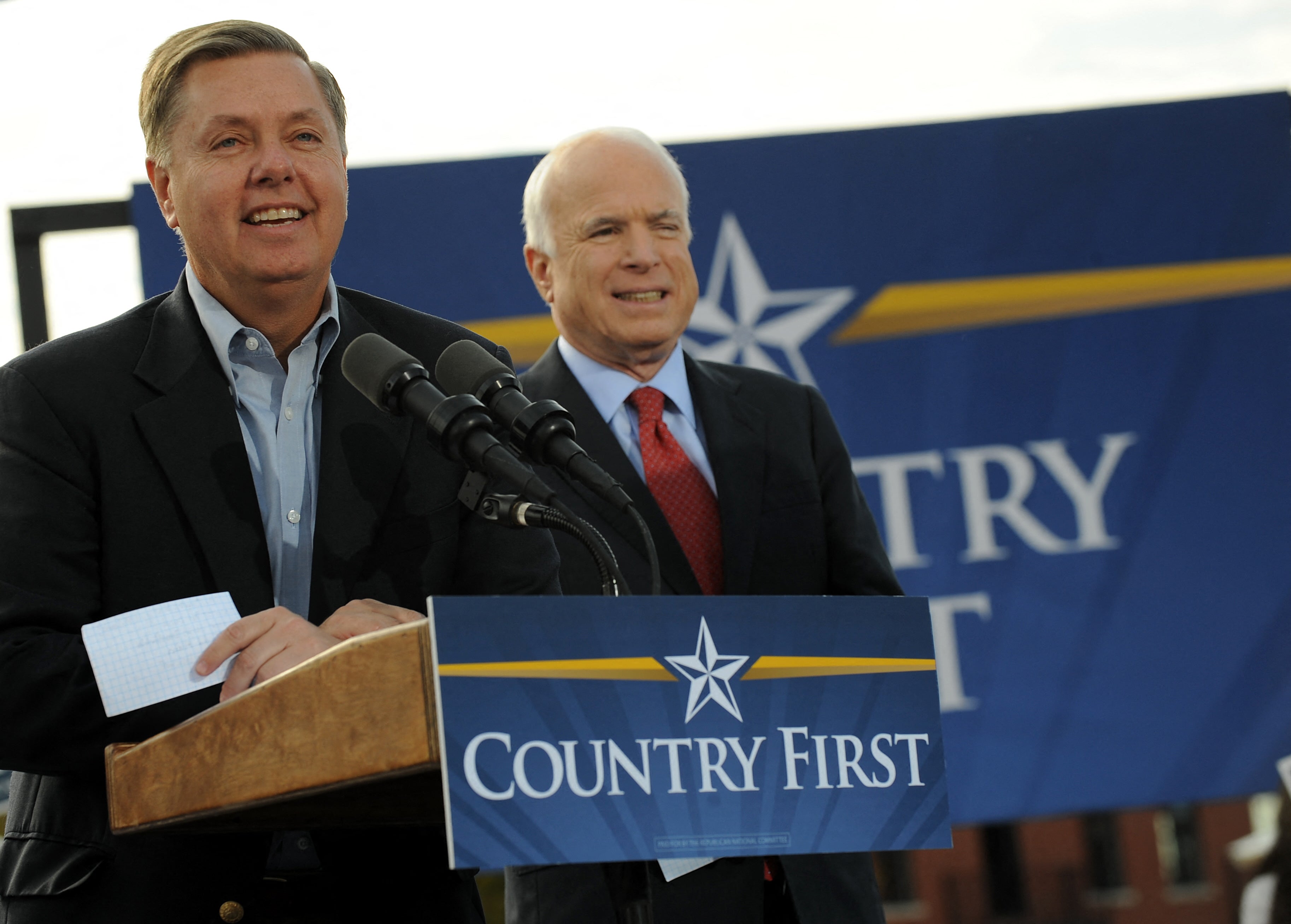 Graham (L) introduces Republican presidential candidate John McCain (R) at a campaign rally at New Town at St Charles in St Charles, Missouri, on October 20, 2008