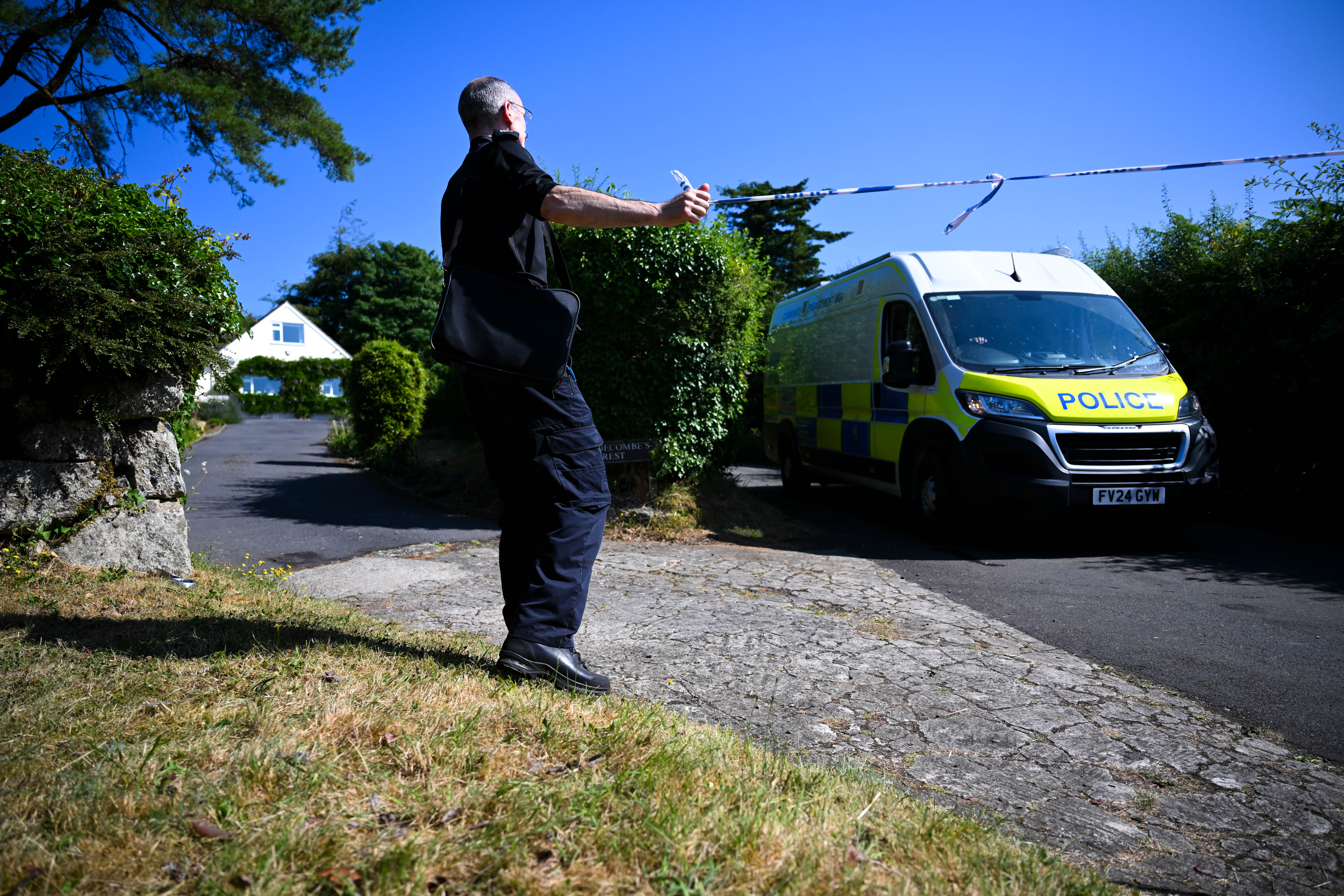 A police officer stands outside the house of Ann Widdecombe in Haytor on Saturday