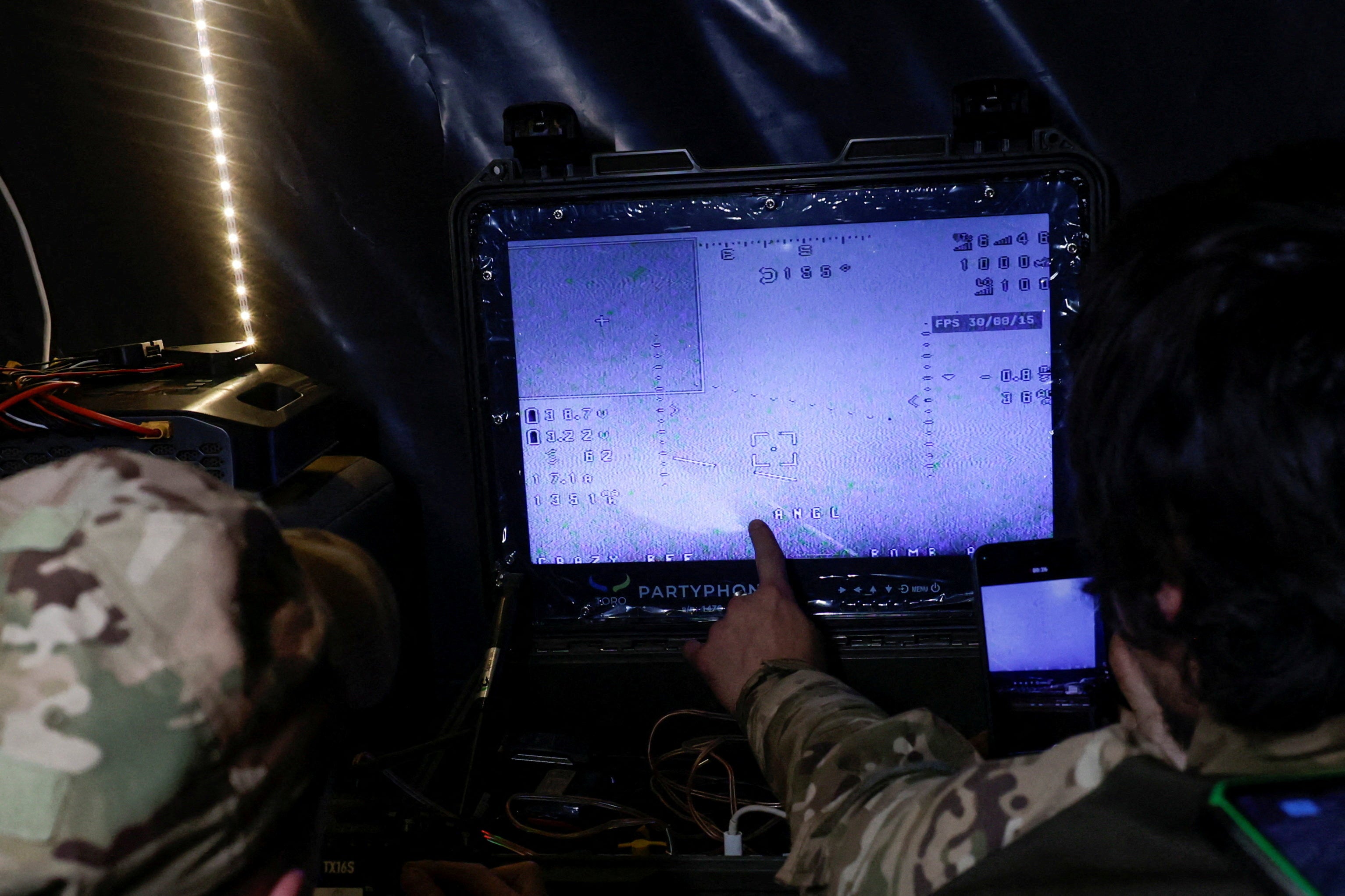 Servicemen of the 66th Separate Mechanized Brigade named after Prince Mstyslav the Brave control a Darts middle range strike unmanned aerial vehicle which flies toward Russian troops in a front line (Reuters)