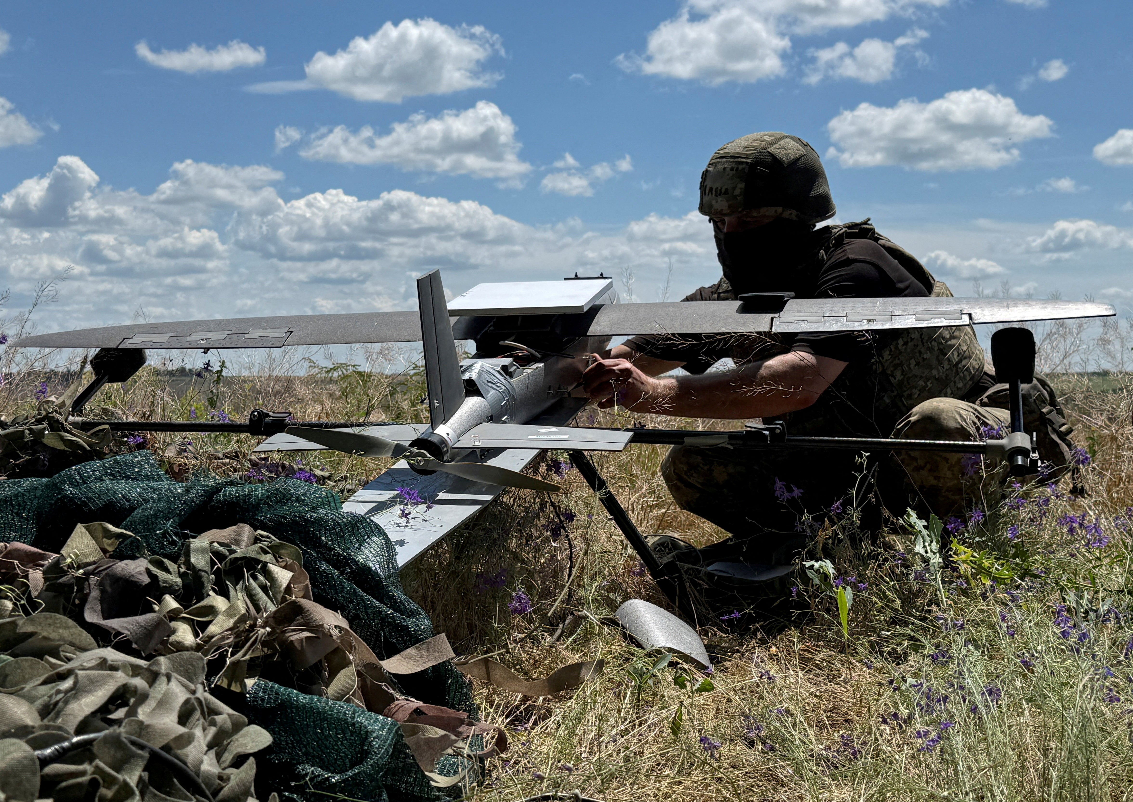 A serviceman of the 25th Separate Airborne Brigade of the Air Assault Forces of Ukraine prepares to launch a Hornet middle strike drone towards Russian troops from a position near a front line (Reuters)