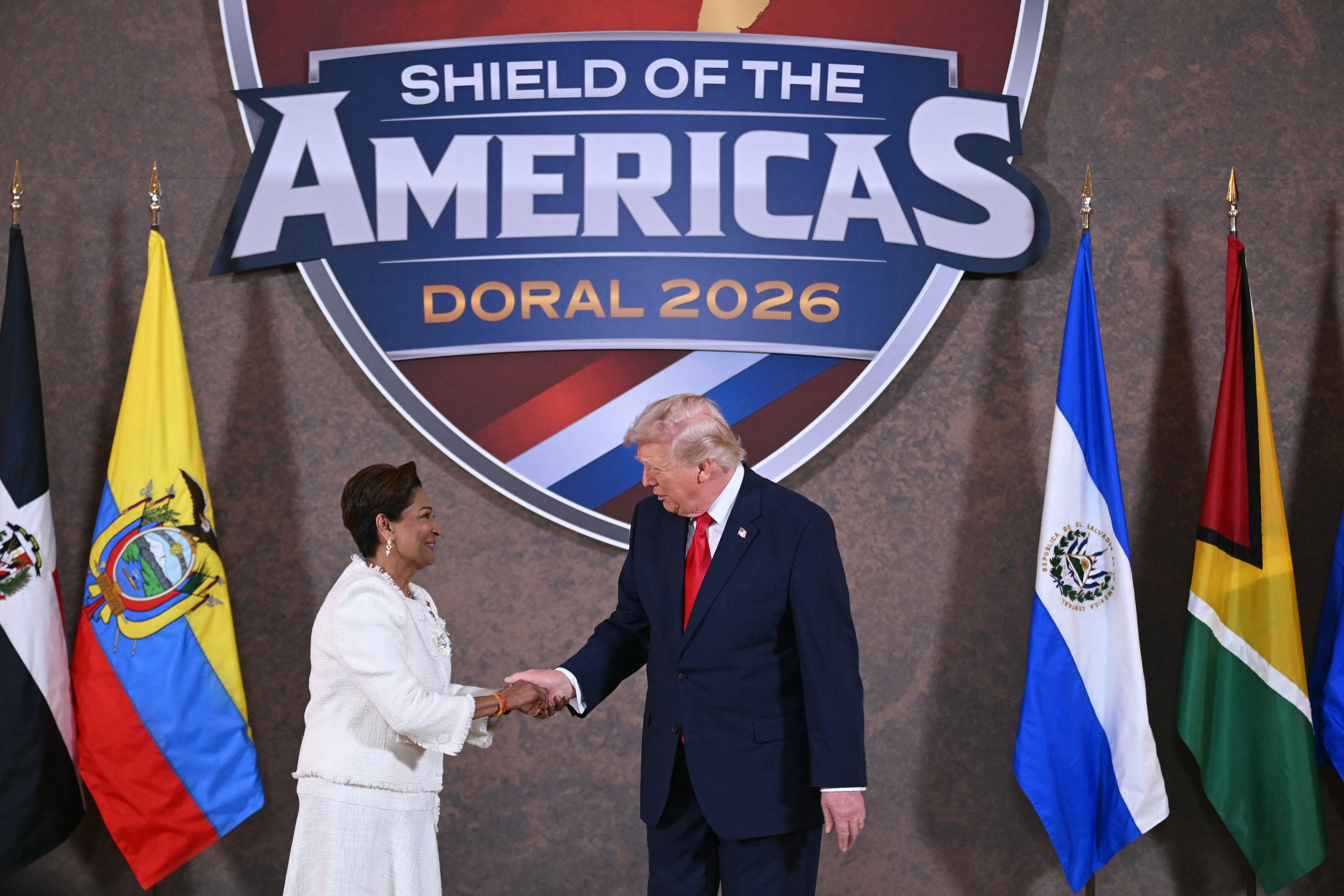 President Donald Trump poses with Trinidad and Tobago's Prime Minister Kamla Persad-Bissessar
