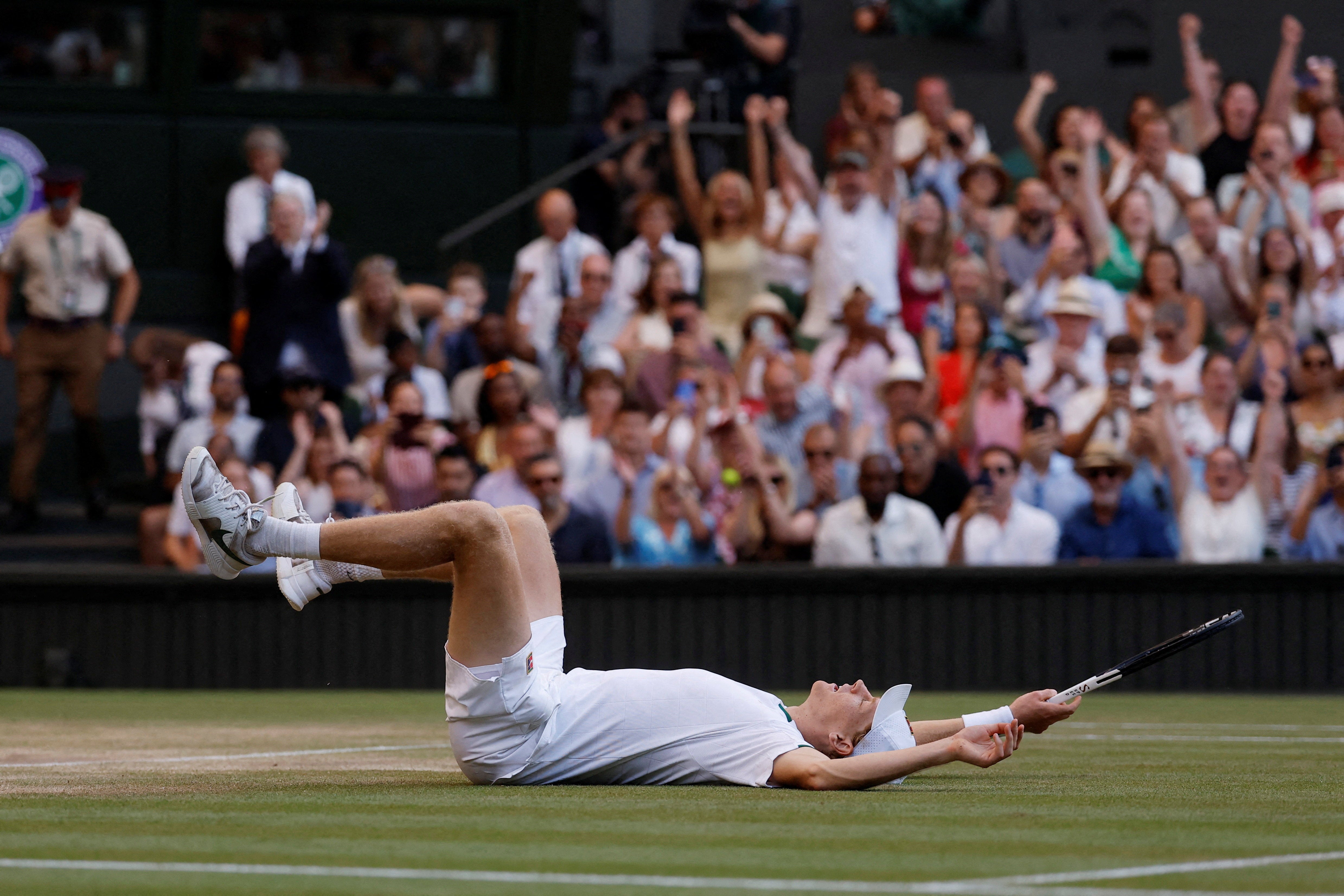 Sinner falls onto his back after beating Zverev in four tight sets