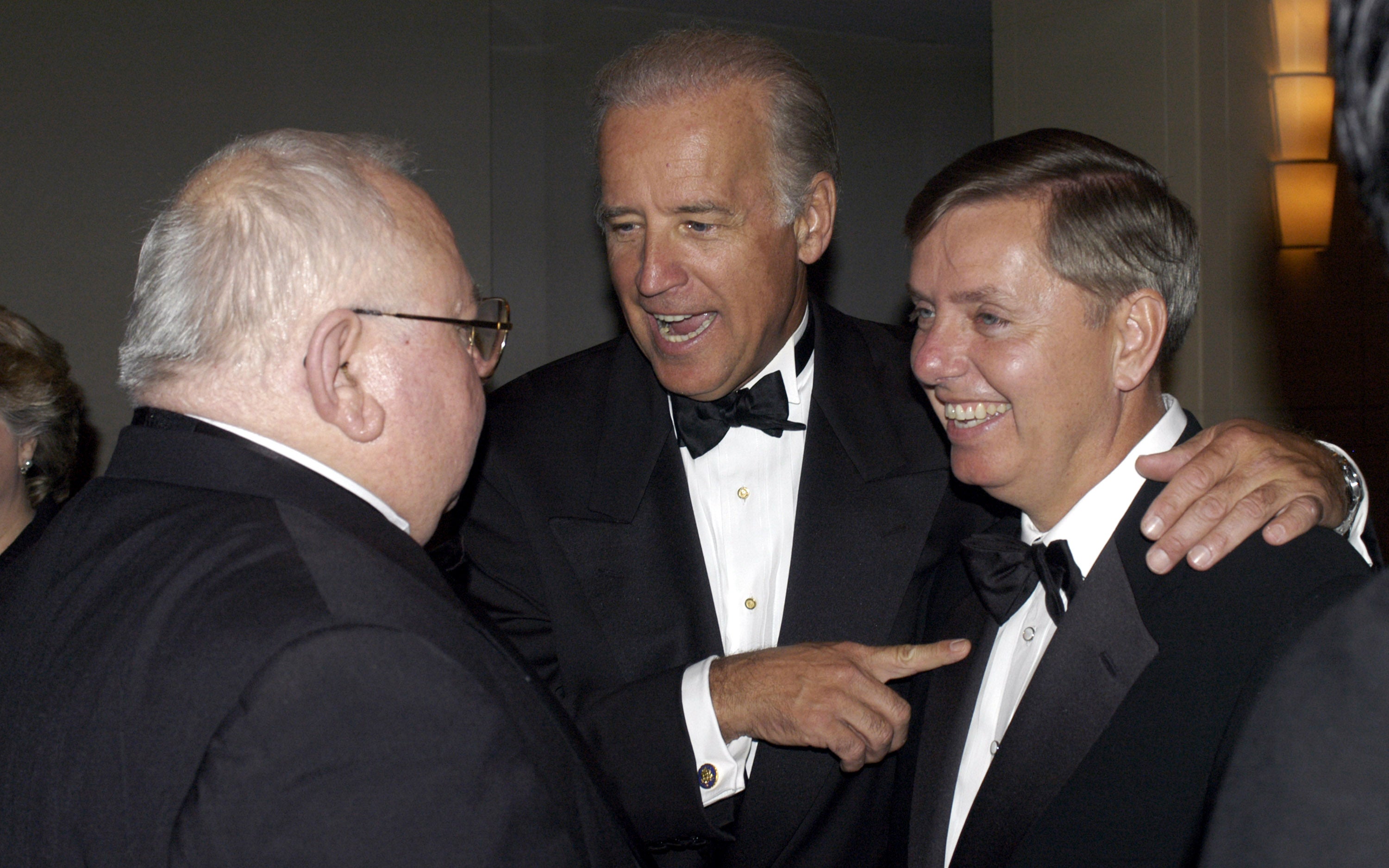 Future president and then-senator Joe Biden introduces Graham to Lee Ewing of Aerospace Daily at a black tie gala in 2004