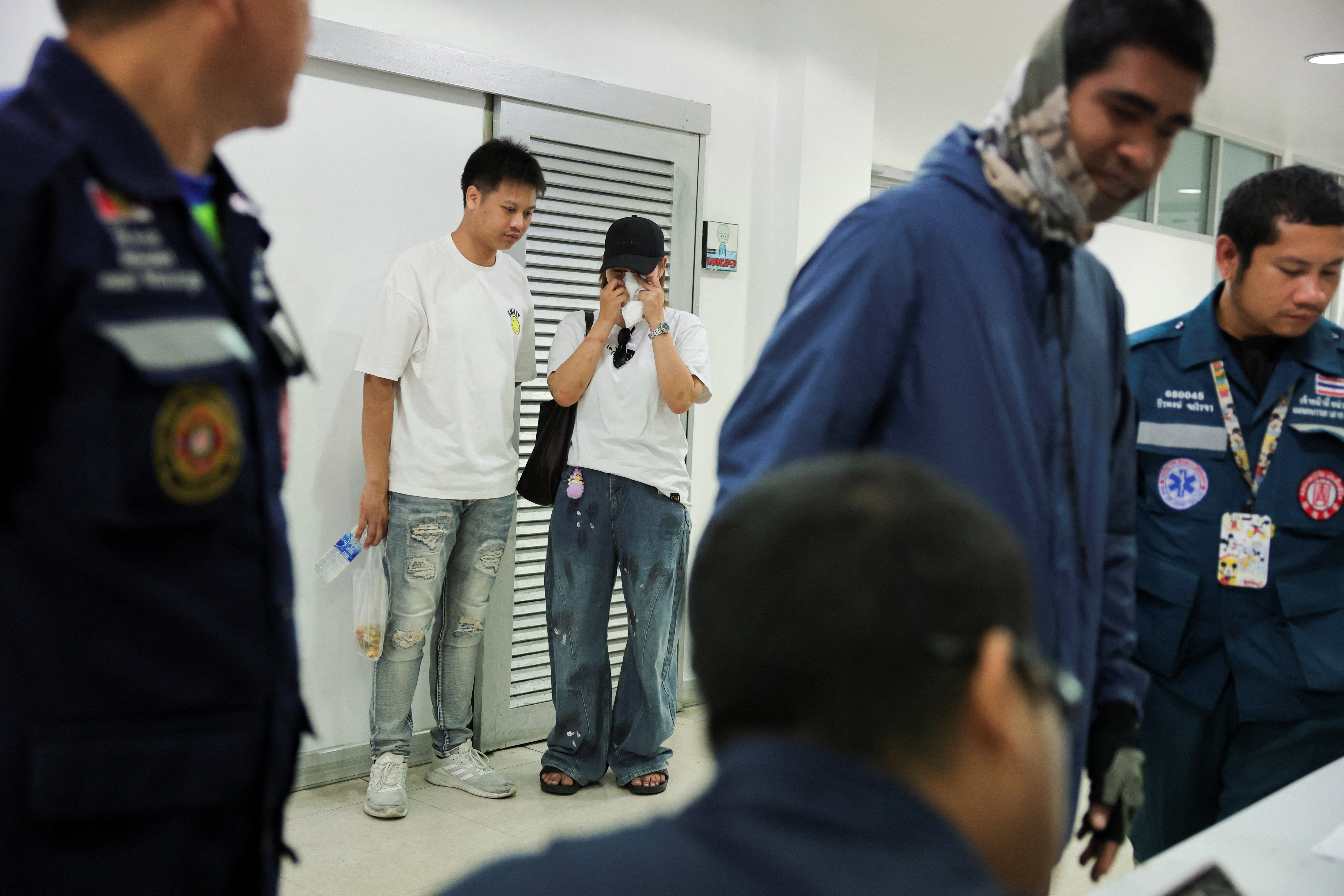Nuttakarn Sevoy, a friend of a victim, reacts after identifying the body at the Police hospital morgue, following a deadly fire at a pub
