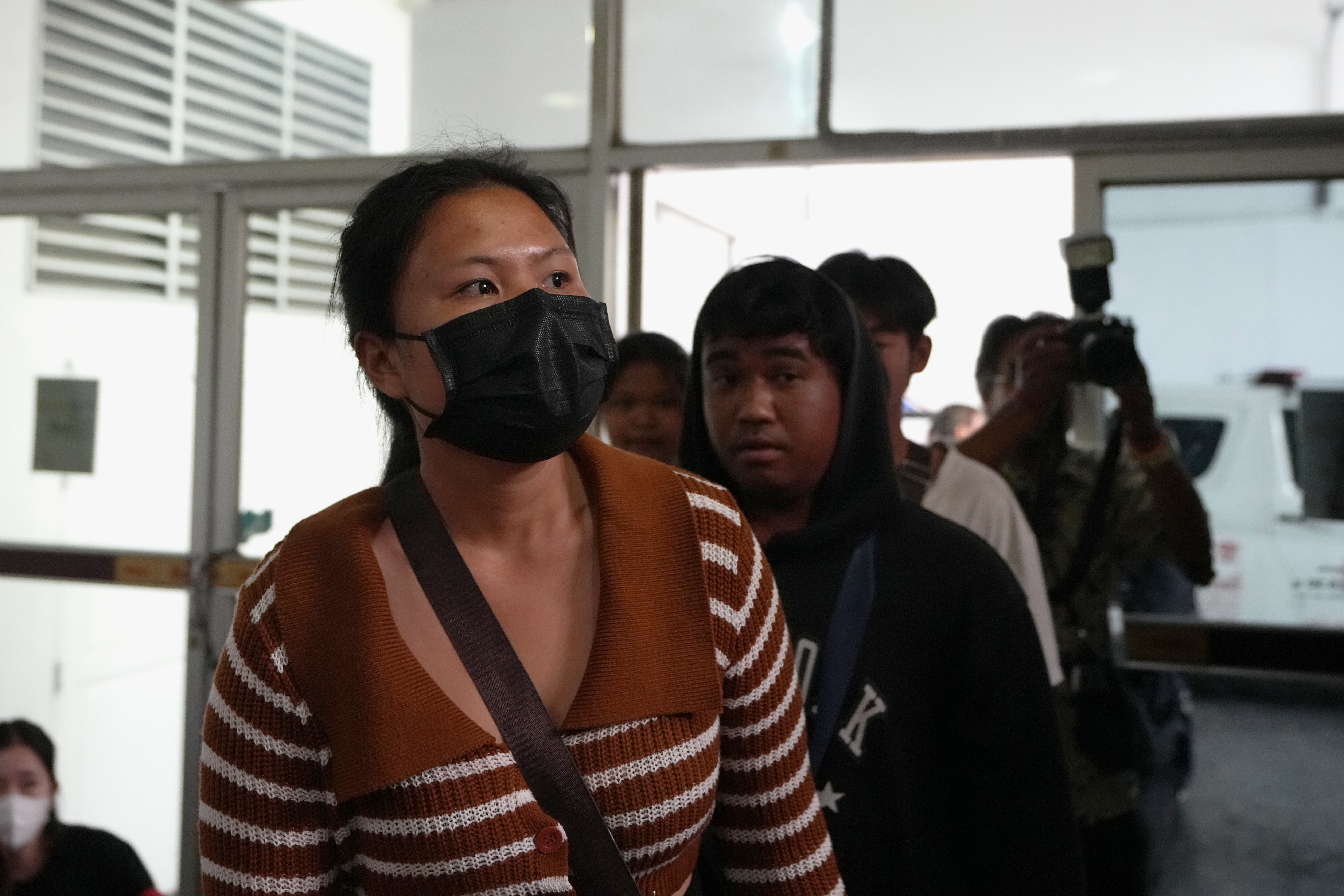 Relatives of fire victims arrive at the Institute of Forensic Police hospital in Bangkok (AP)