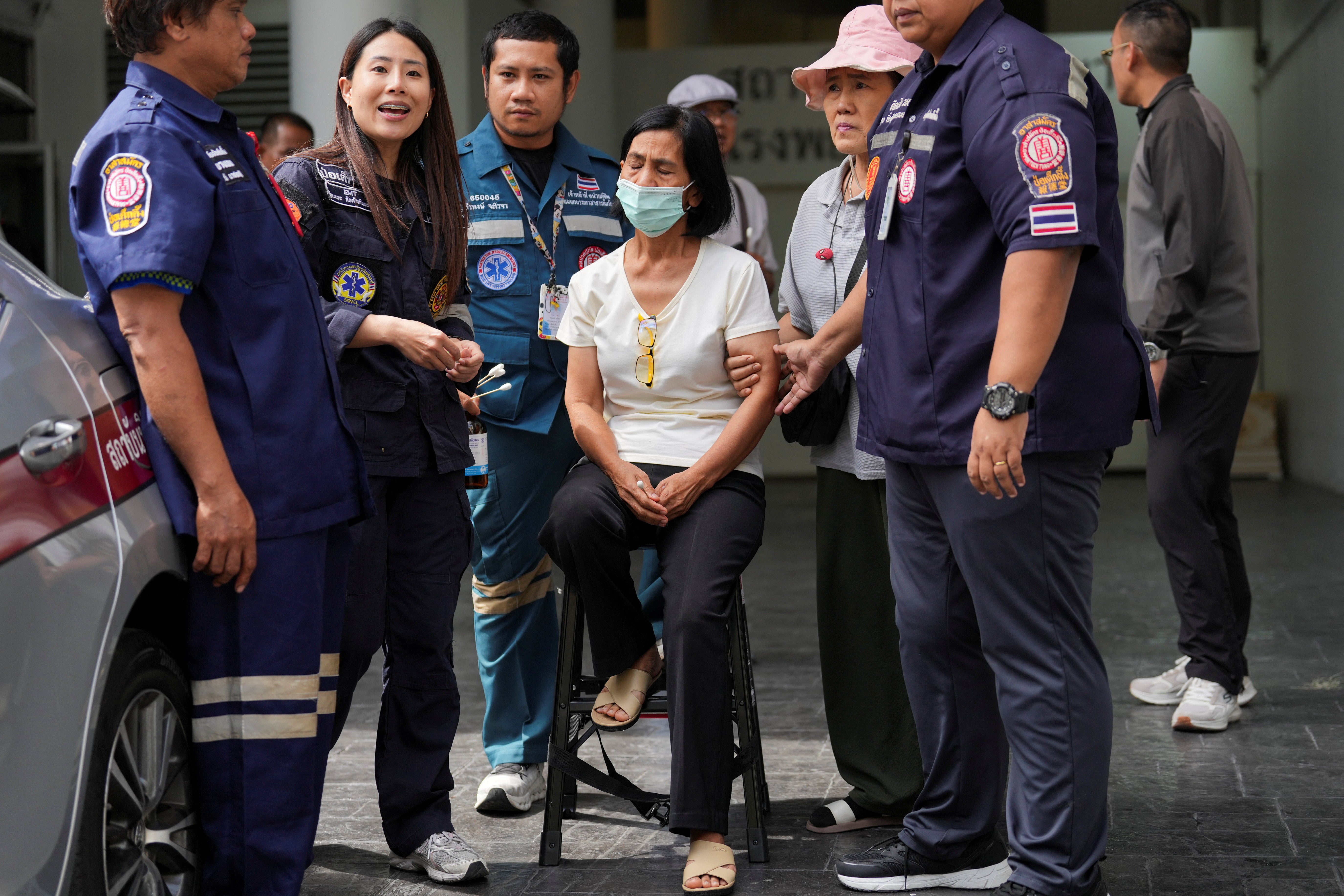 A relative reacts after identifying a body following a deadly fire at a pub in Bangkok, Thailand, on 13 July 2026