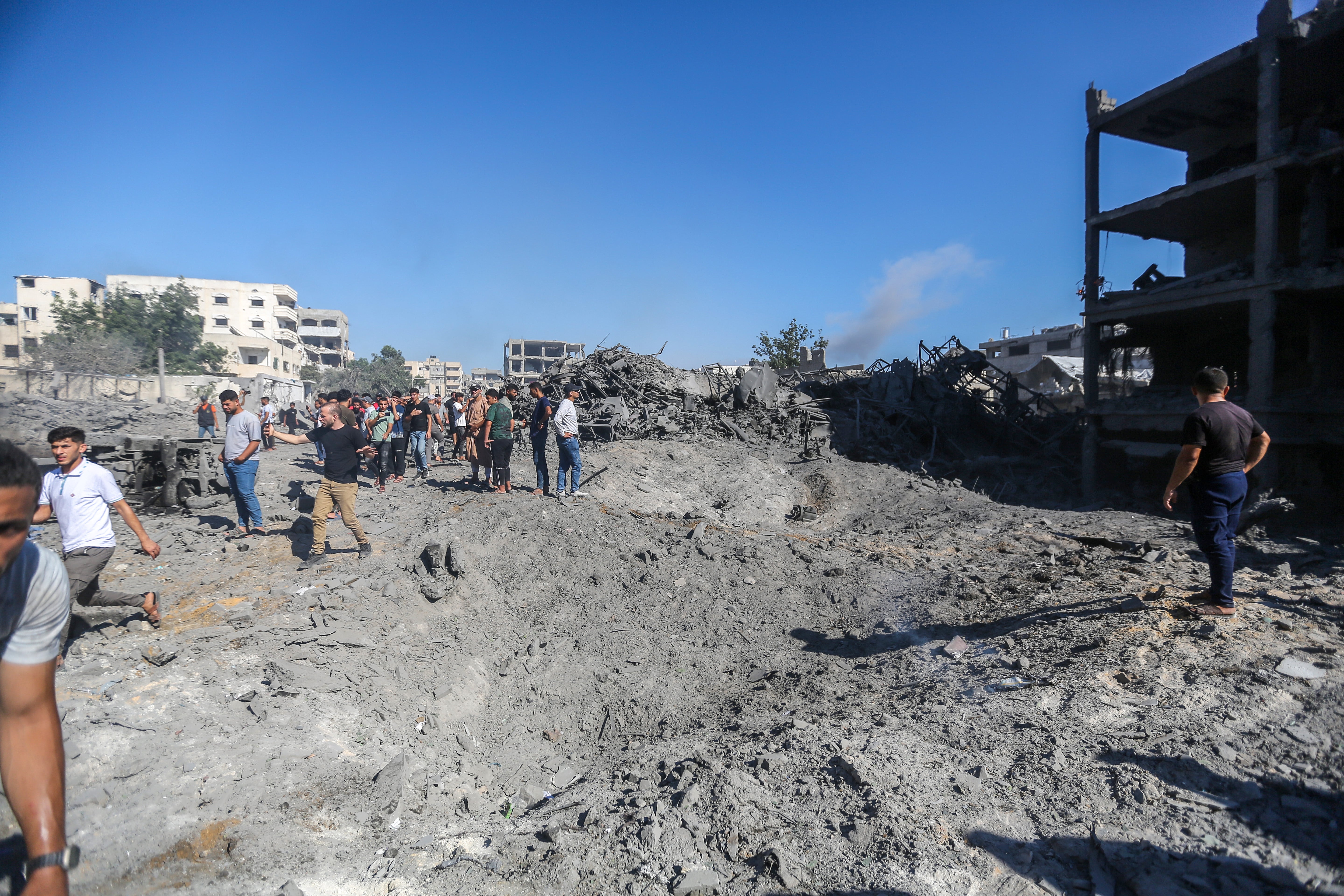 People inspect the damage after the Israeli air strikes on July 12, 2026 in Gaza City, Gaza