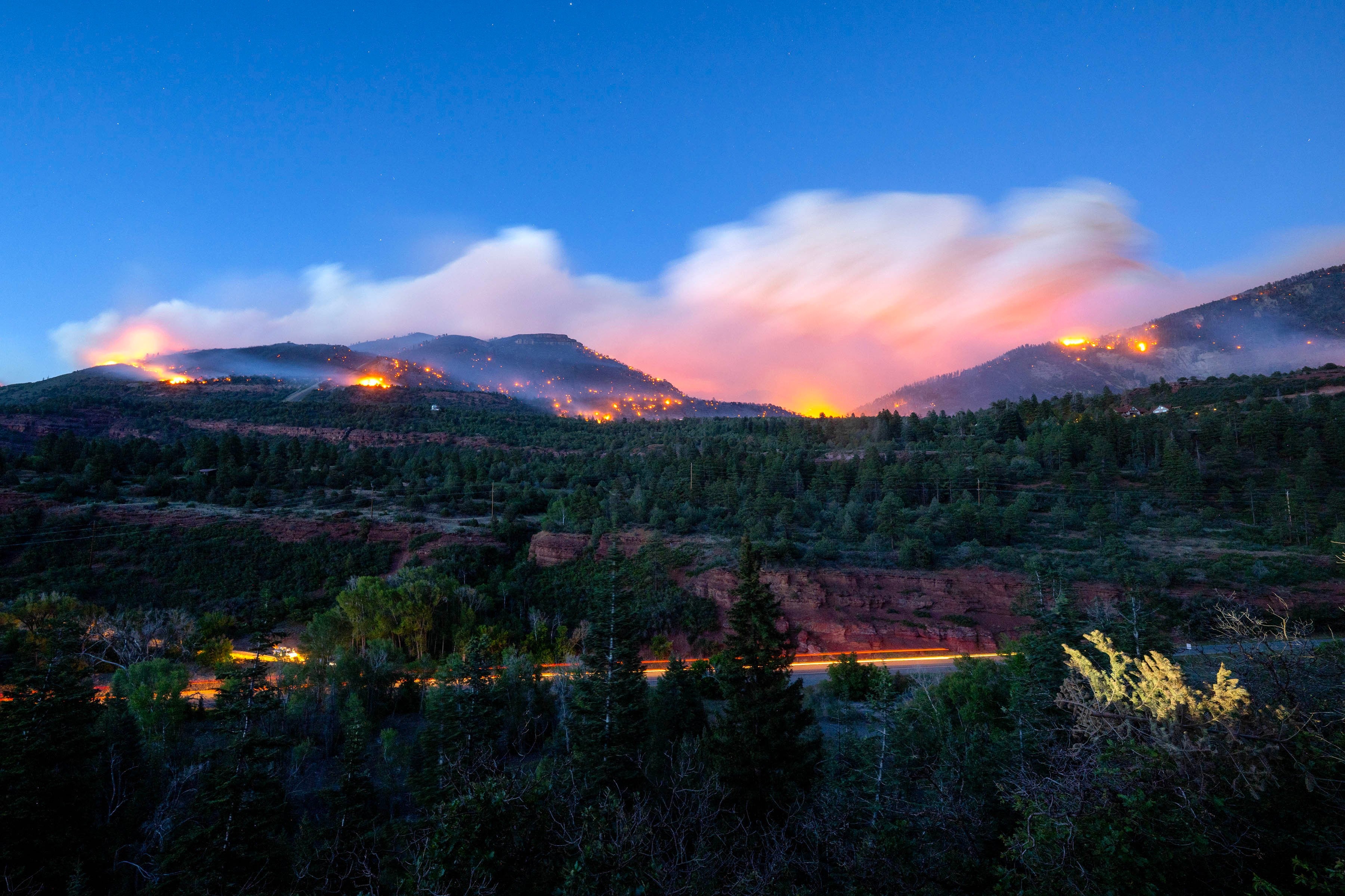 Firefighters drive along Highway 550 as they try to access the Gold Mountain Fire on the town line of Ouray and Ridgeway, Colorado