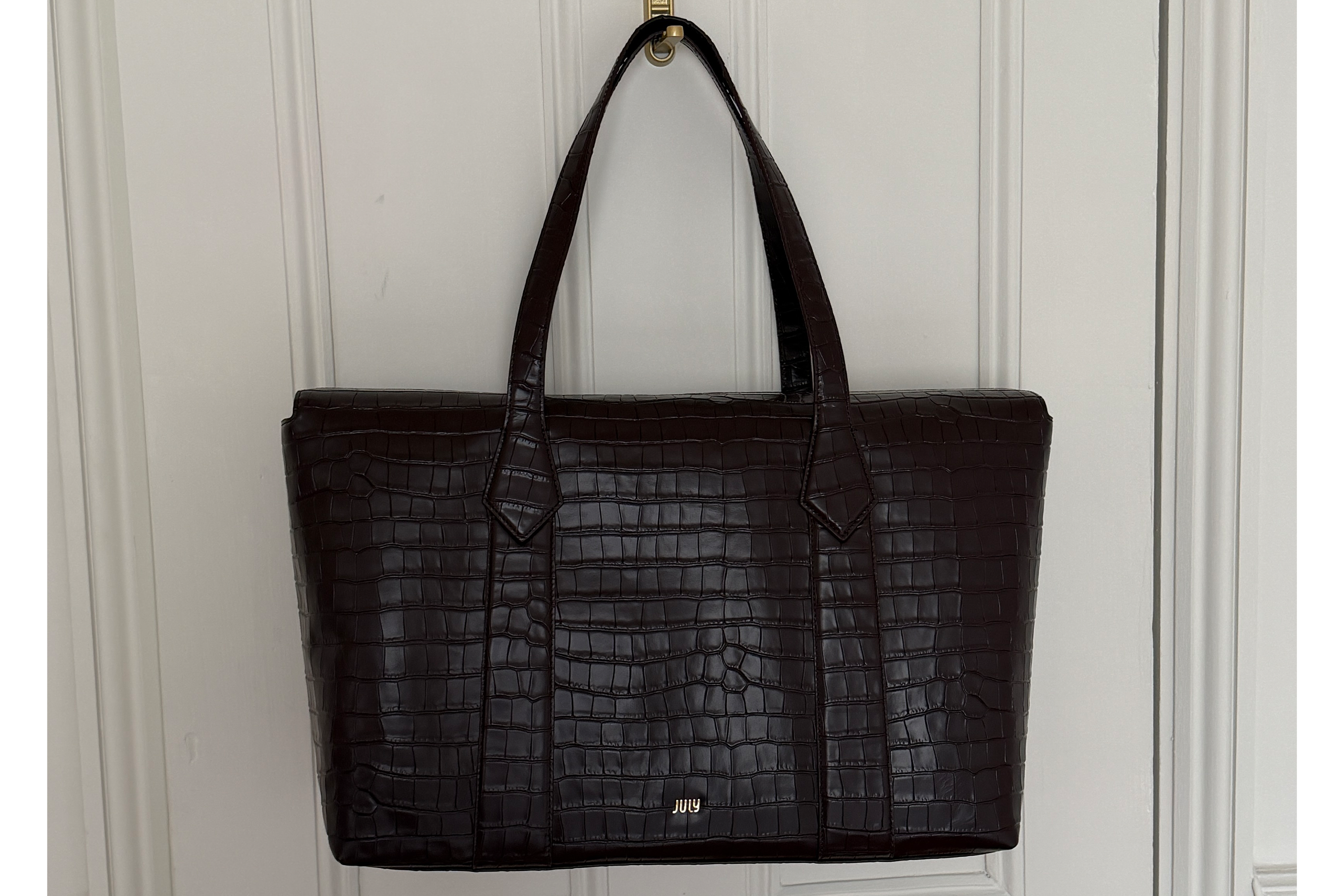 The croc print leather makes this bag work trip appropriate (Harriet Davey/The Independent)