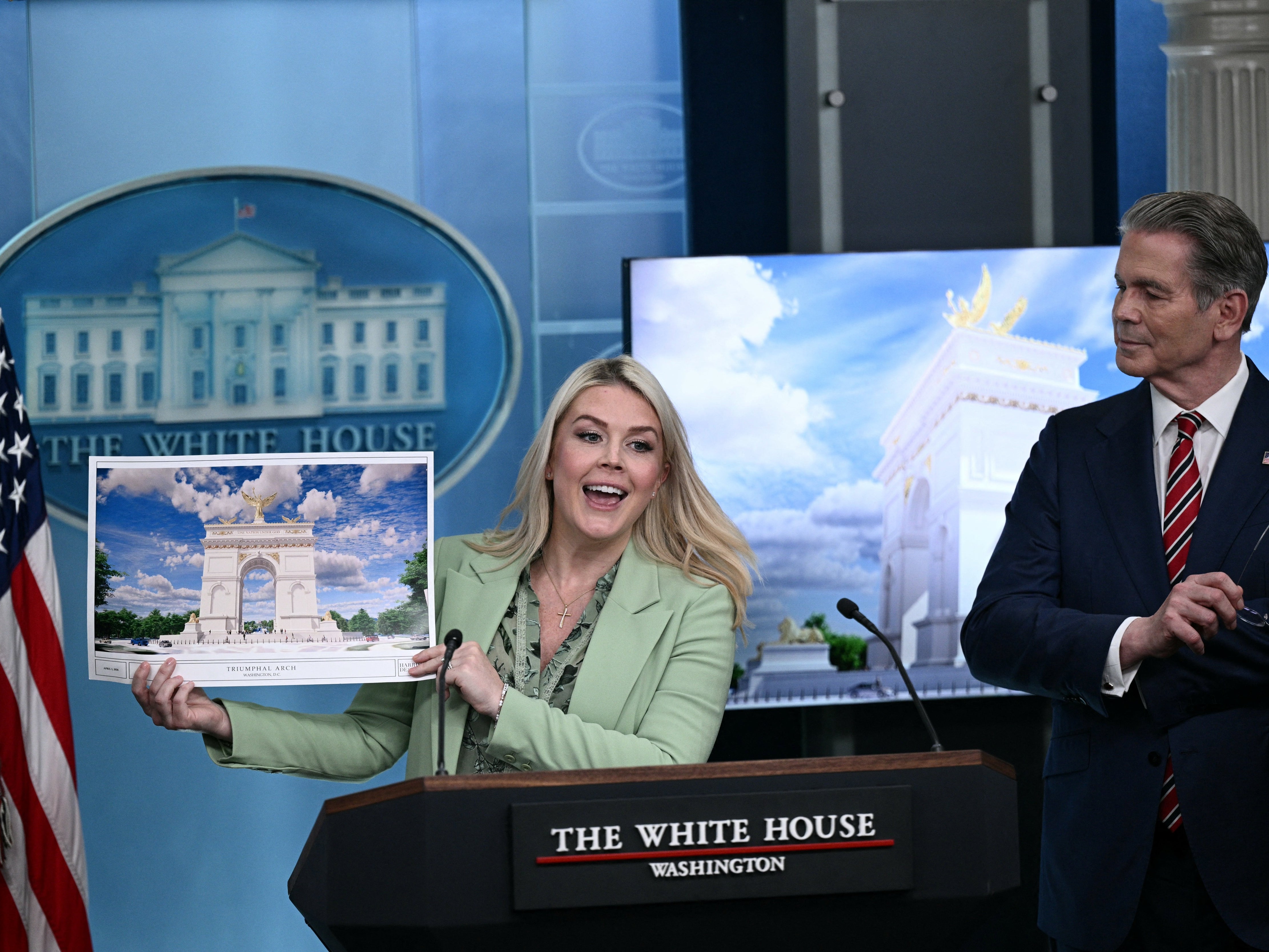 Secretary of Treasury Scott Bessent looks on as White House Press Secretary Karoline Leavitt shows an artist's rendering of Trump's planned arch, which would tower over all DC structures. (AFP via Getty Images)