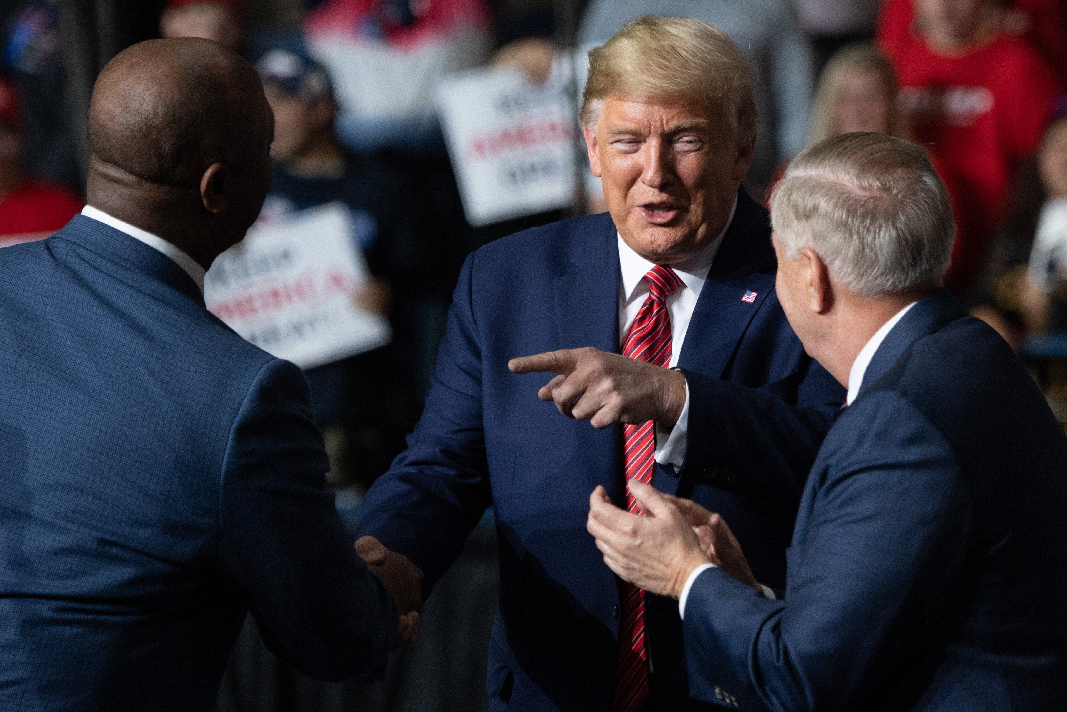 Scott, Graham, and Trump are pictured during a 2010 campaign rally