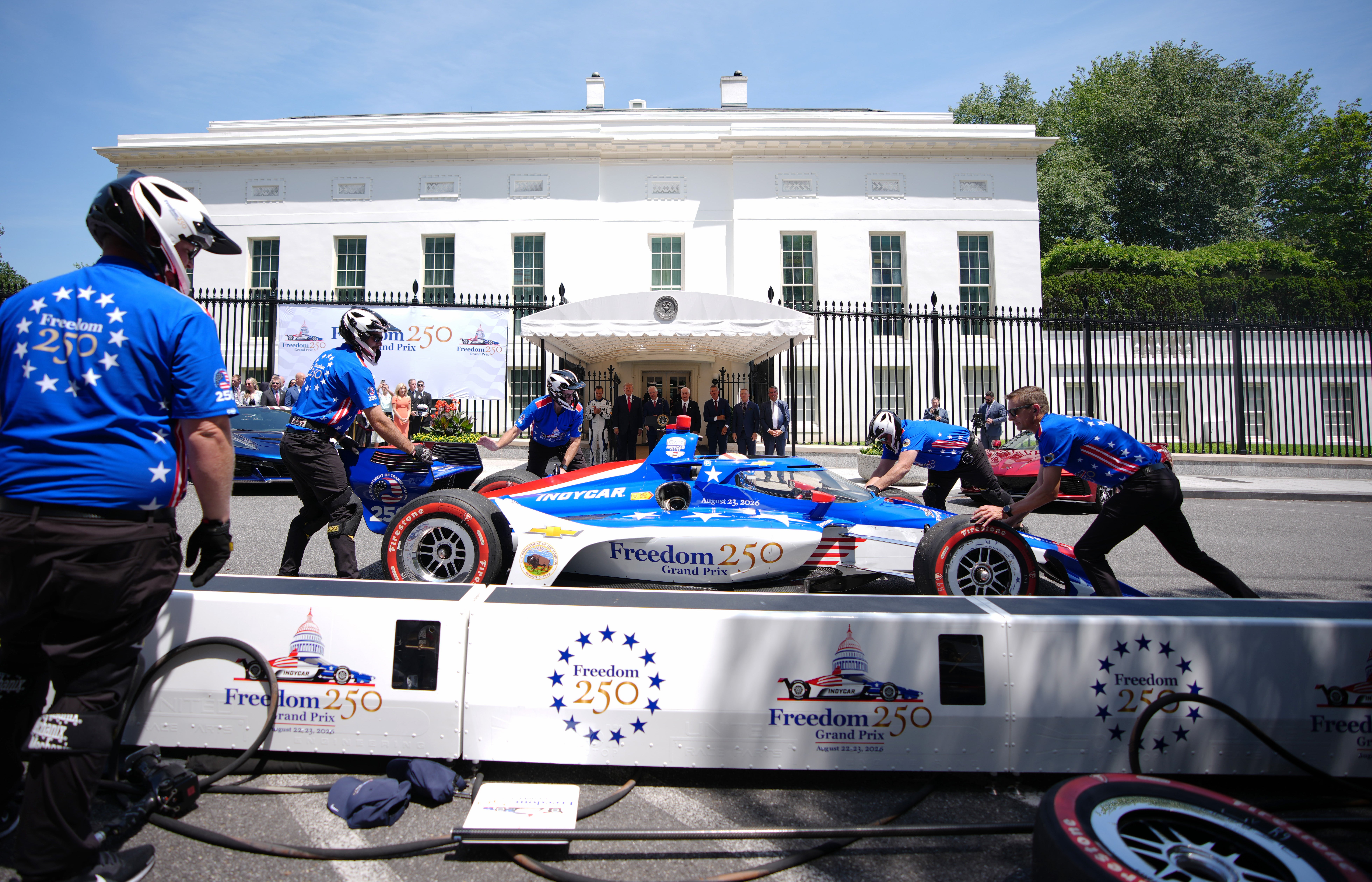 Trump was all smiles when a Freedom 250 race car pulled up to the White House during the event, and a crew jumped into action to perform a lightning-fast pit stop