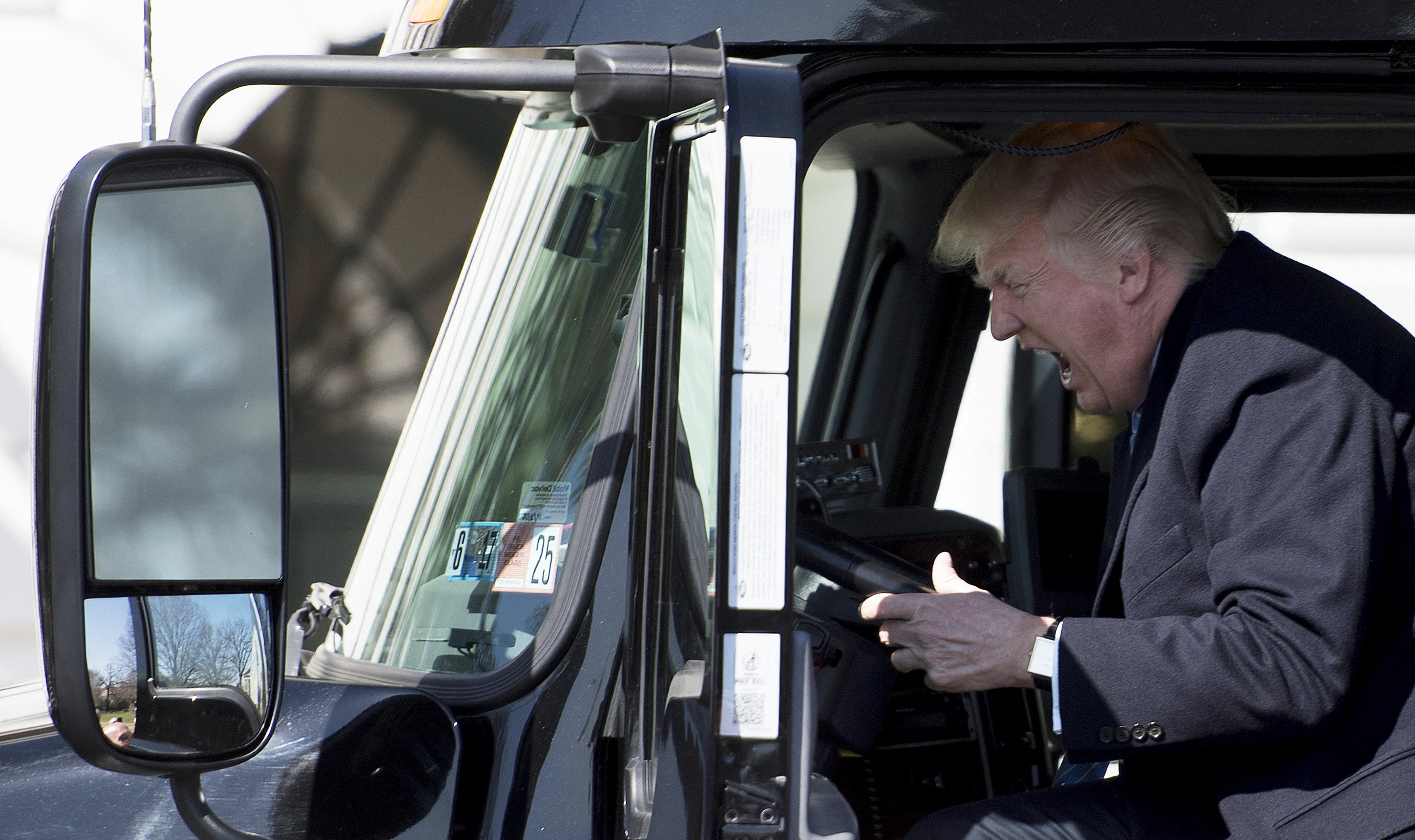 Trump reacts excitedly while sitting in a truck at the White House in 2017