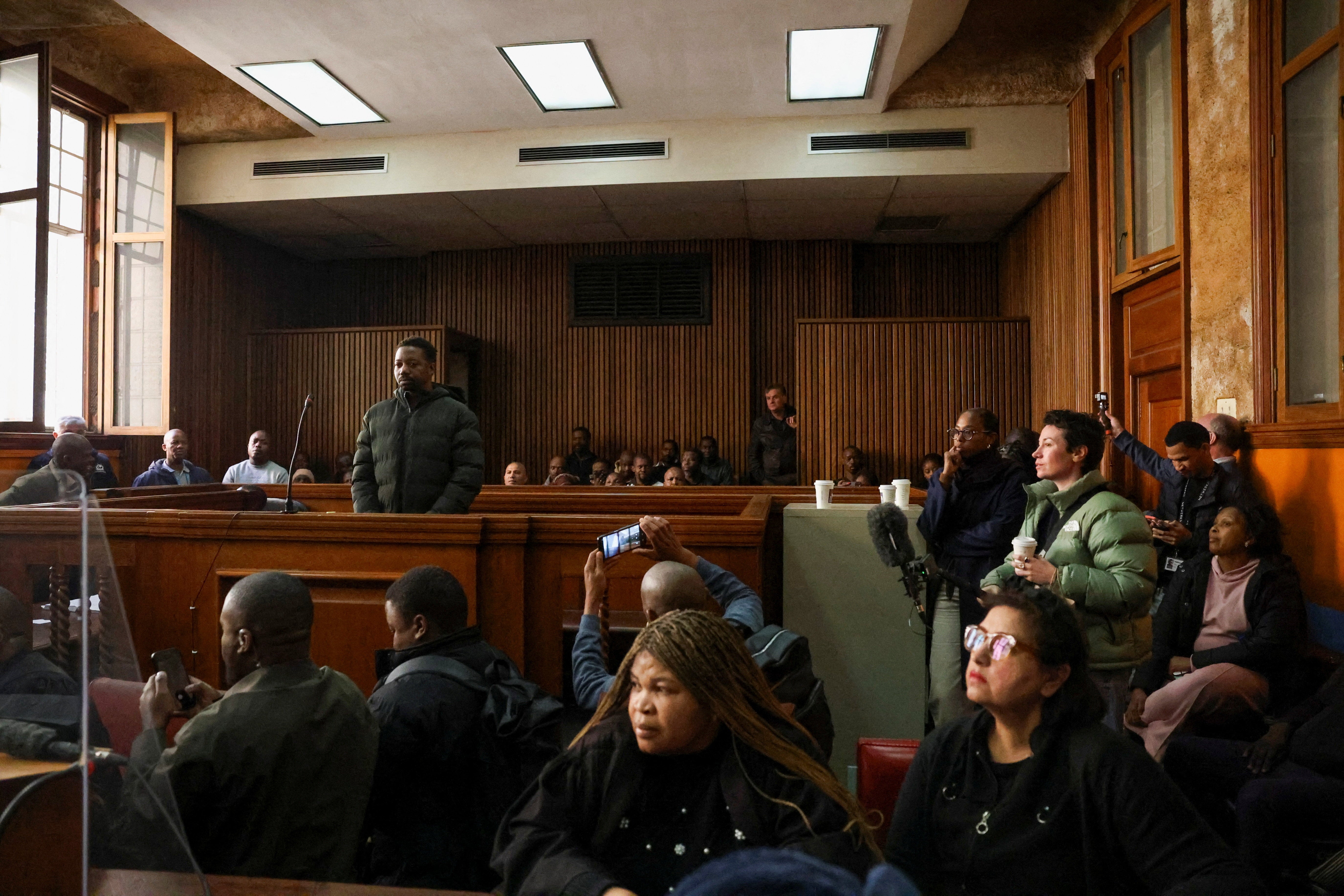 Ndodana Mkhanyisi Tshuma, a British citizen of Zimbabwean heritage, wanted by British authorities in connection with the murder of his wife and two daughters in Bedfordshire, appears at the Johannesburg Central District Magistrate's Court, in Johannesburg, South Africa, July 13, 2026. REUTERS/Oupa Nkosi