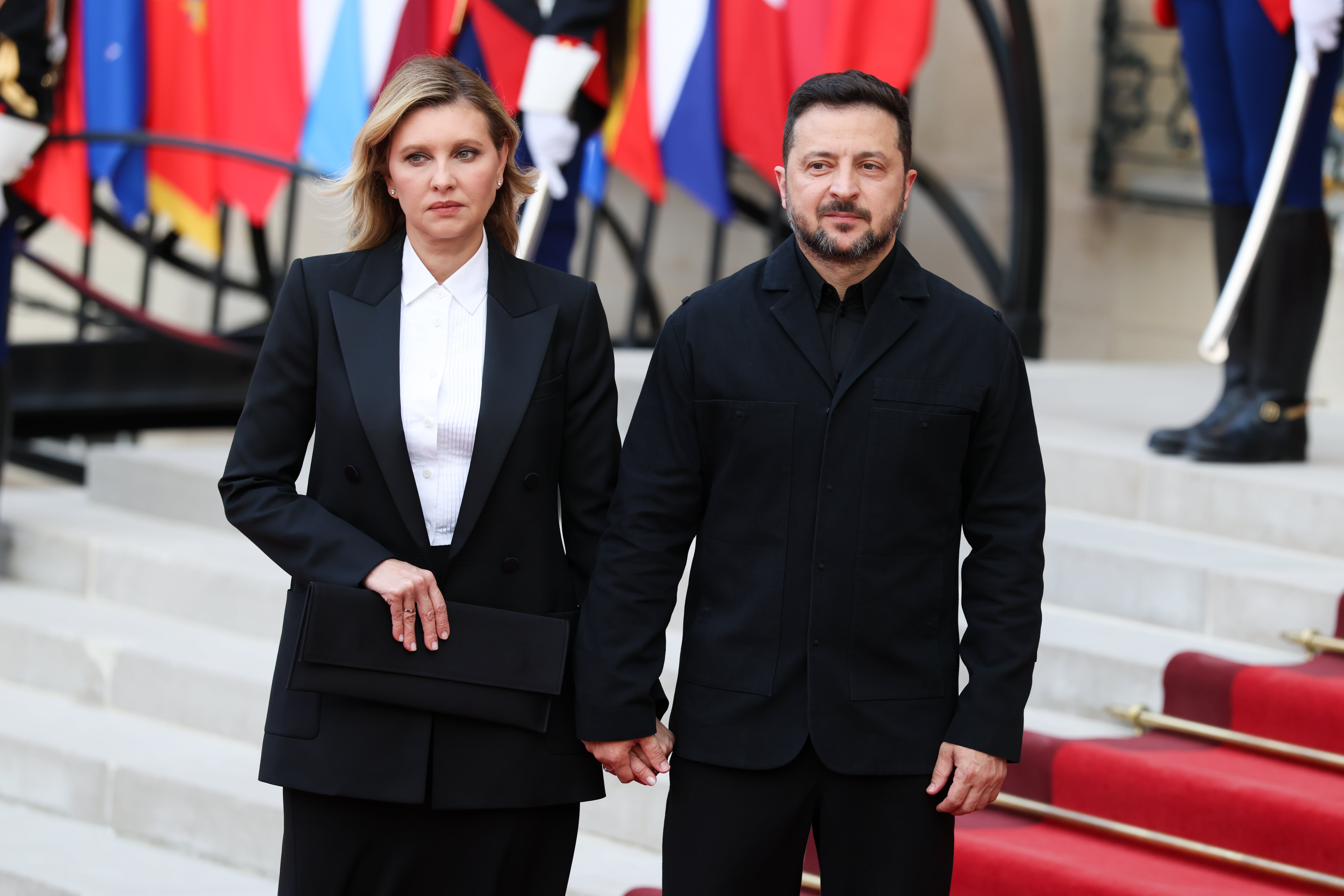Ukraine's President Volodymyr Zelensky (R) and his wife Olena Zelensky (L) arrive for a dinner during a "Coalition of the Willing" meeting at Elysee Palace.