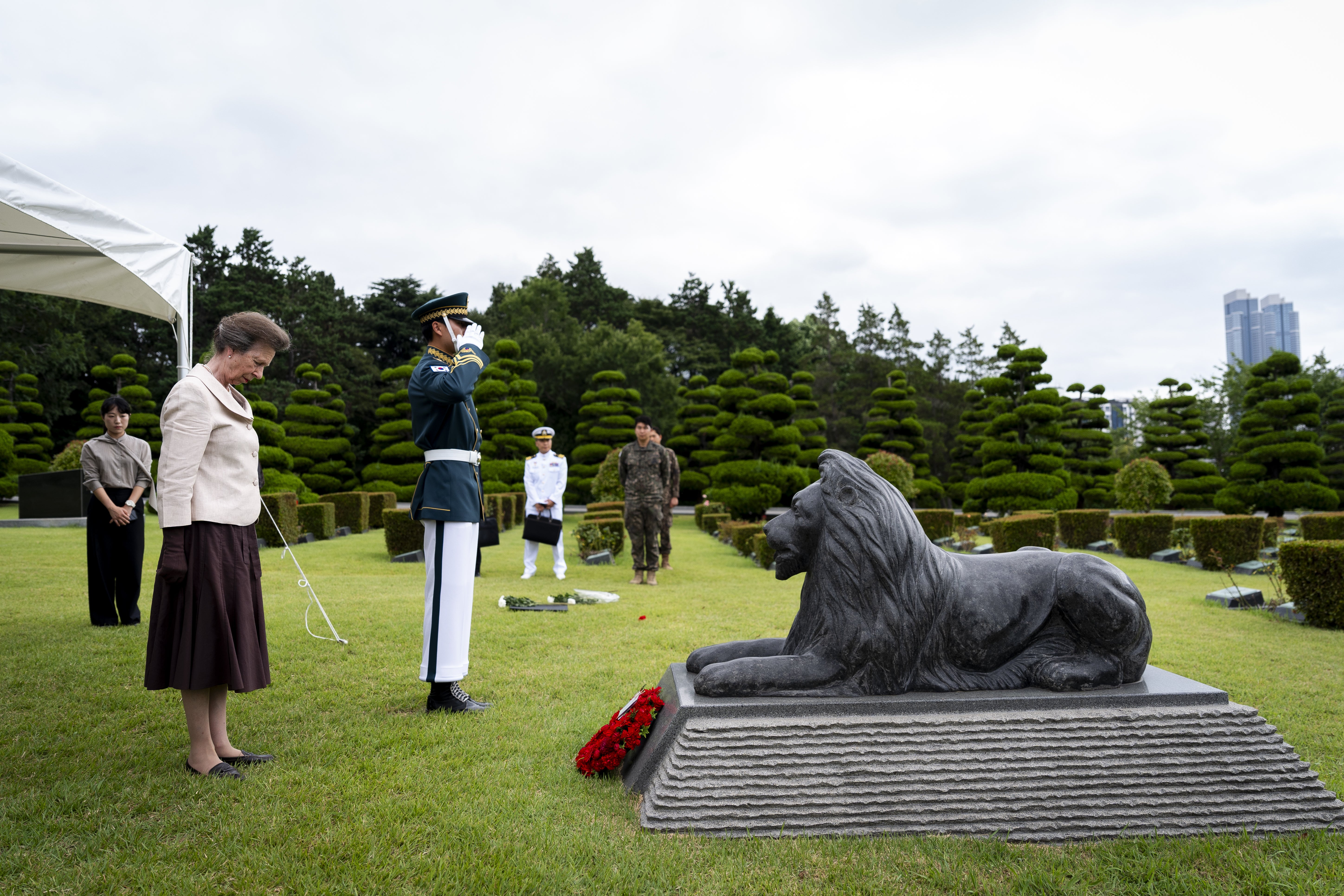 Anne stands in front of the lion statue which stands in honour of UK servicemen who died in the Korean War