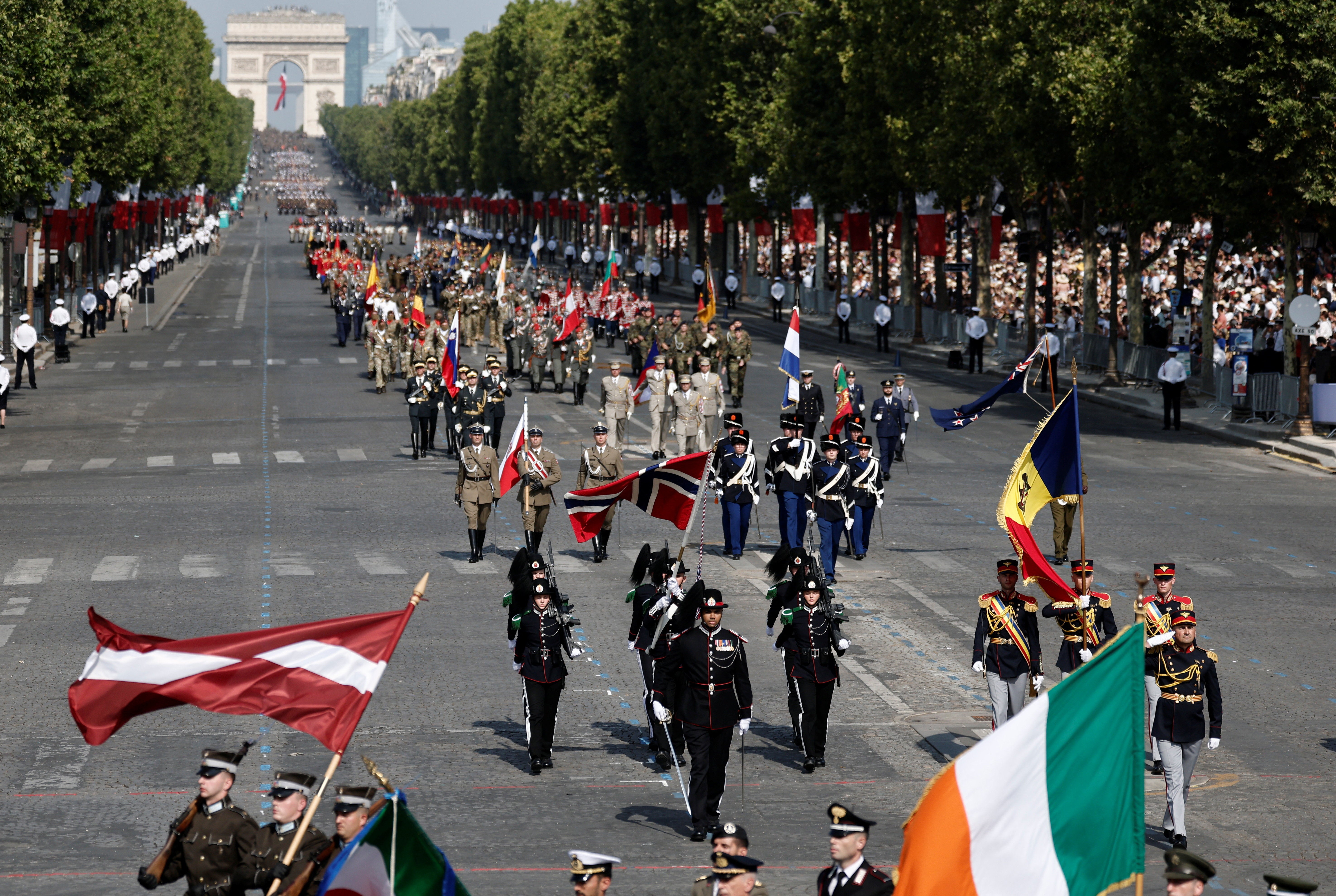 Soldiers from countries of the Coalition of the Willing march during the annual Bastille Day military parade on the Champs-Elysees avenue in Paris