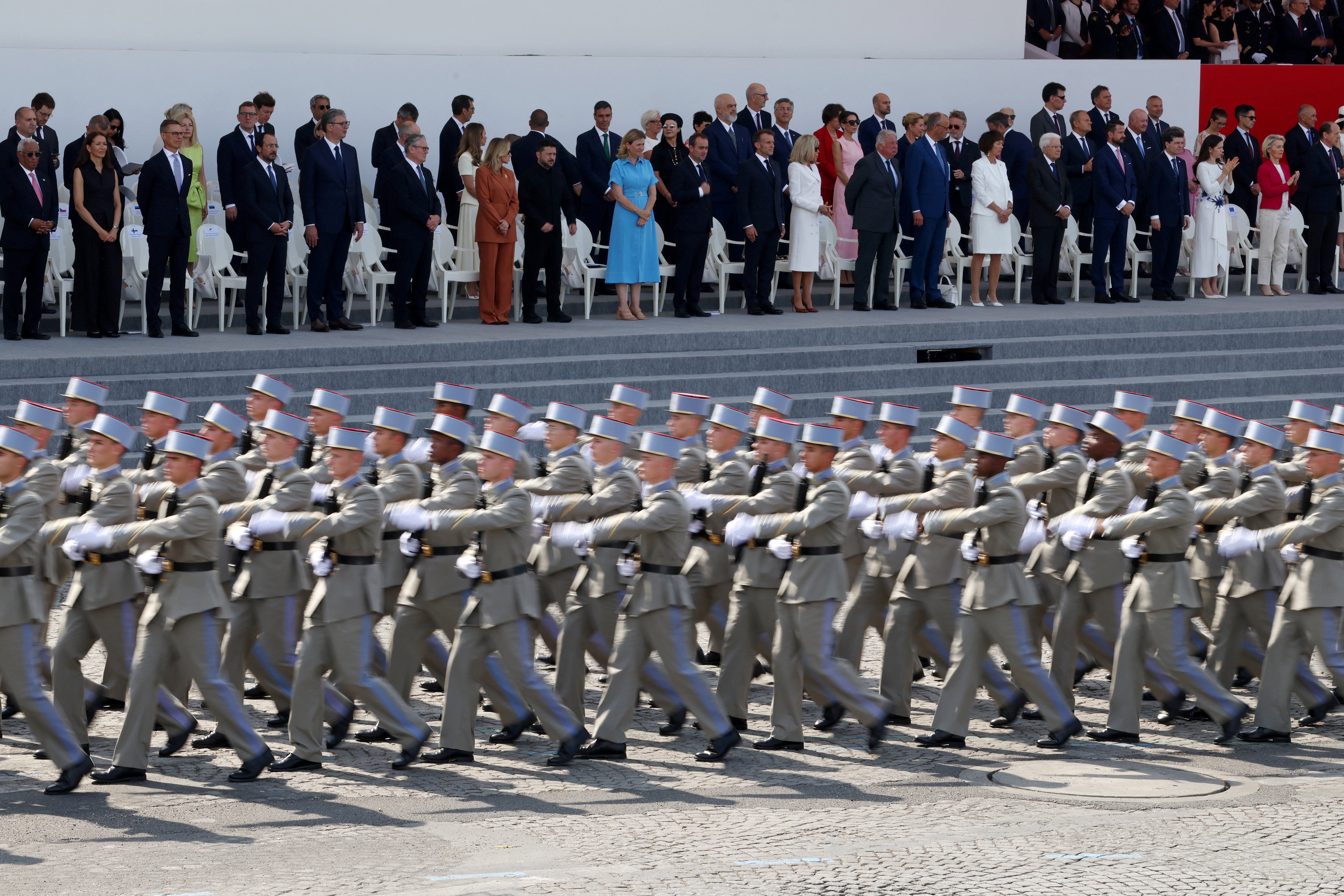 French President Emmanuel Macron, his wife Brigitte Macron, Ukraine's President Volodymyr Zelenskiy and his wife Olena Zelenska, Heads of State and Government of the Coalition of the Willing and members of the French government attend the annual Bastille Day military parade