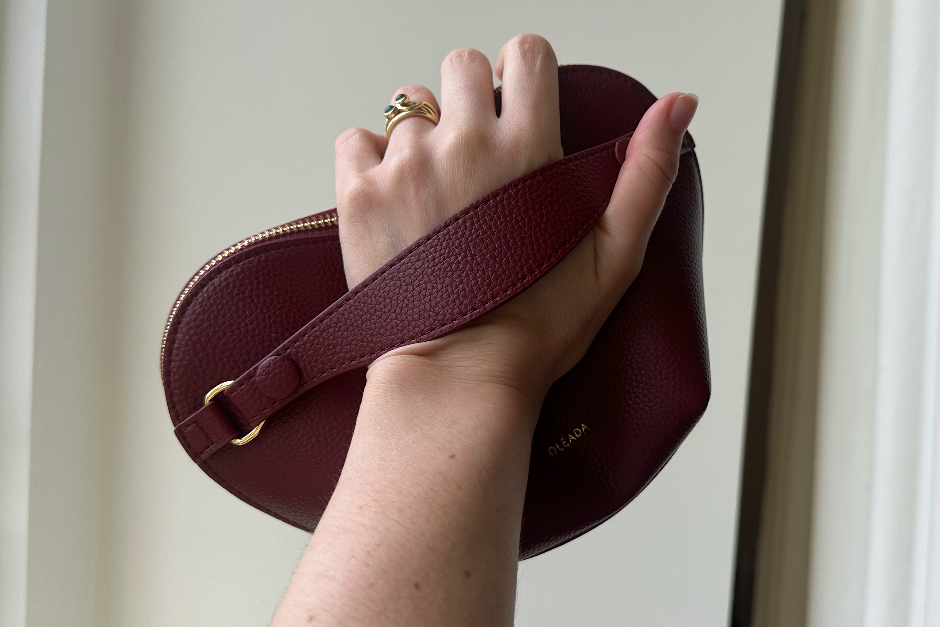 The pouch is held like a handbag (Alessia Armenise/The Independent)