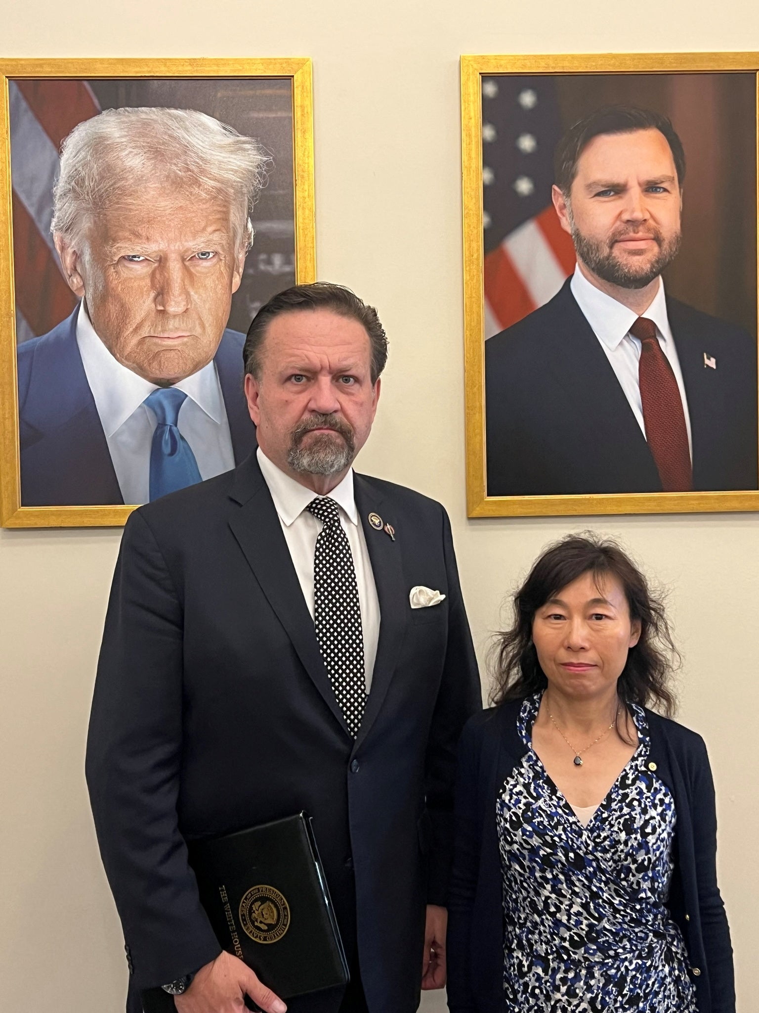 Dr. Yufang Rong, the wife of Dr. Youlin Chen, stands with Sebastian Gorka, deputy national security advisor to U.S. President Donald Trump