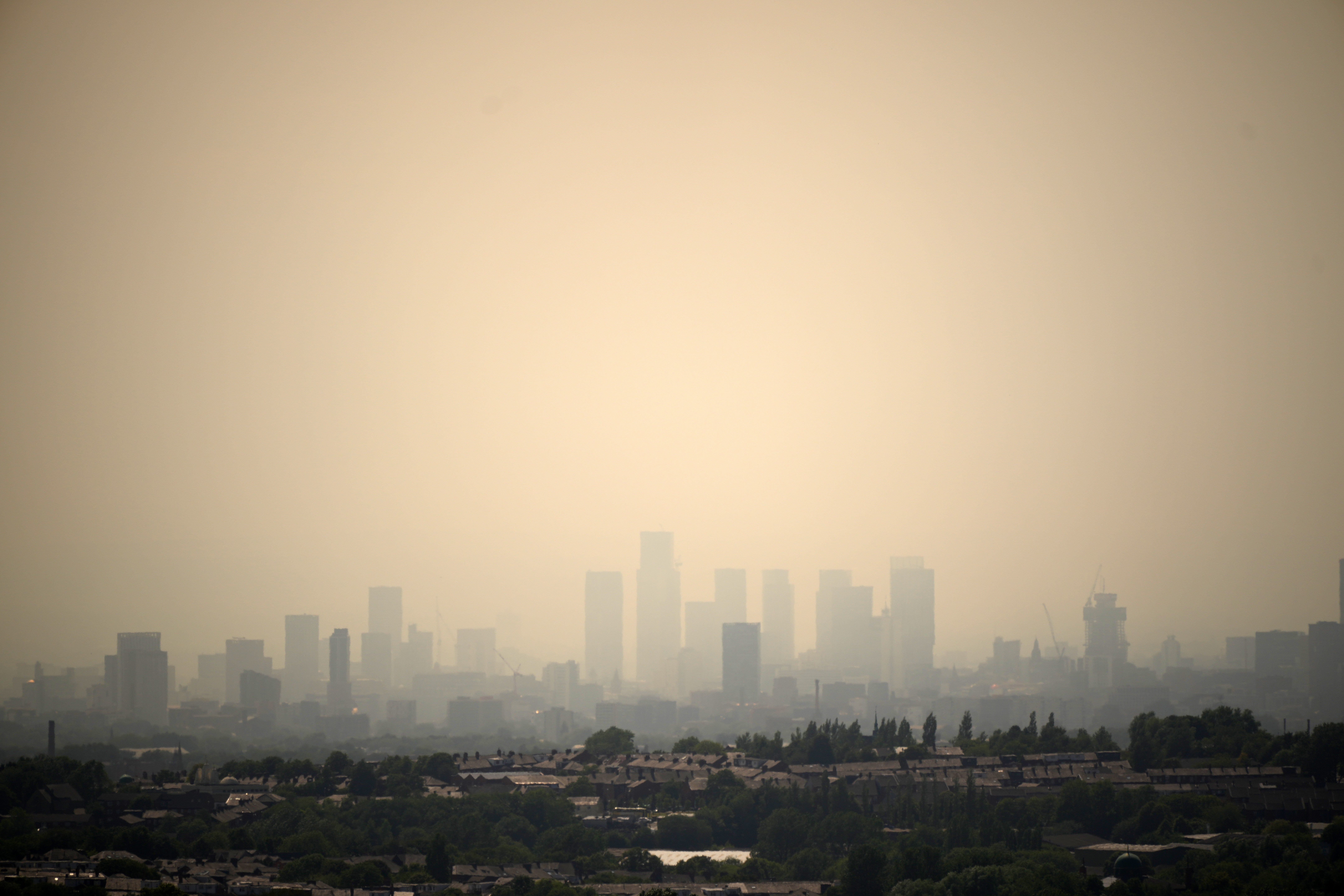 A veil of smoke hangs over the Manchester City skyline during the UK heatwave