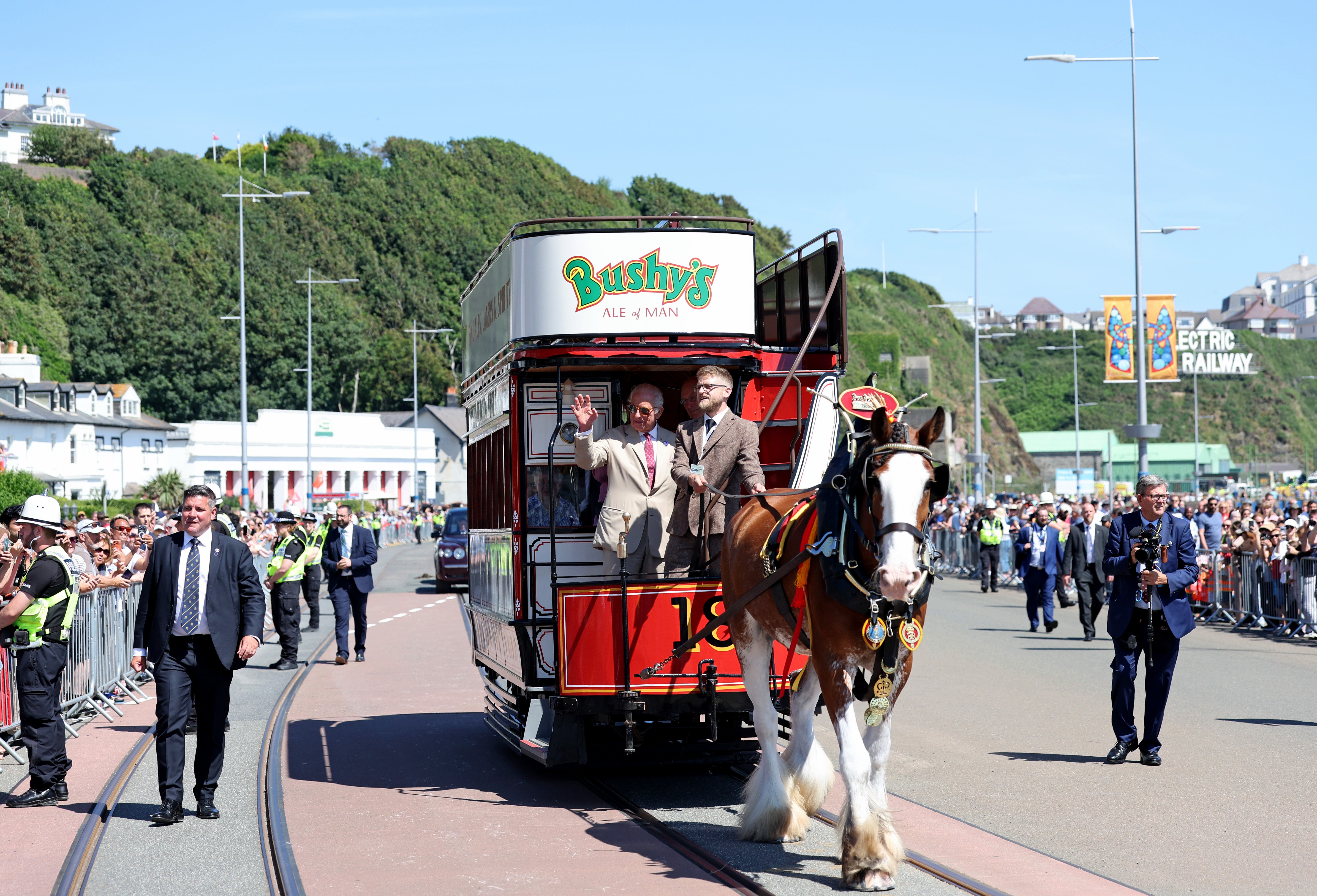 King Charles III, Lord of Mann, takes a ride on one of the horse trams during a visit to Douglas Promenade to celebrate 150 years of the Douglas Horse Tramway, on his trip to the Isle of Man (PA)