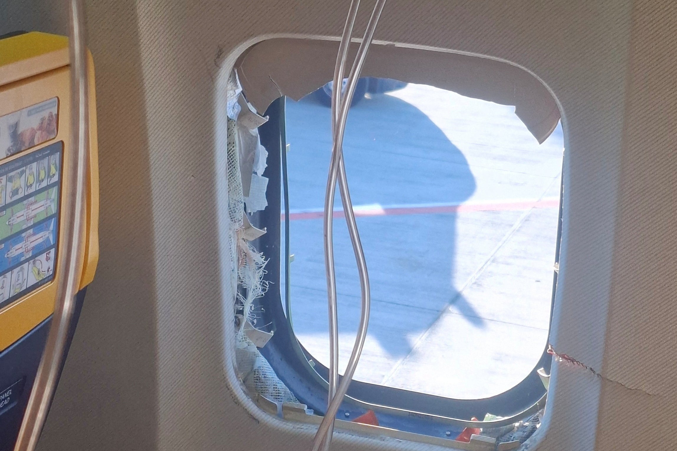 The window was damaged during the flight (Reuters)