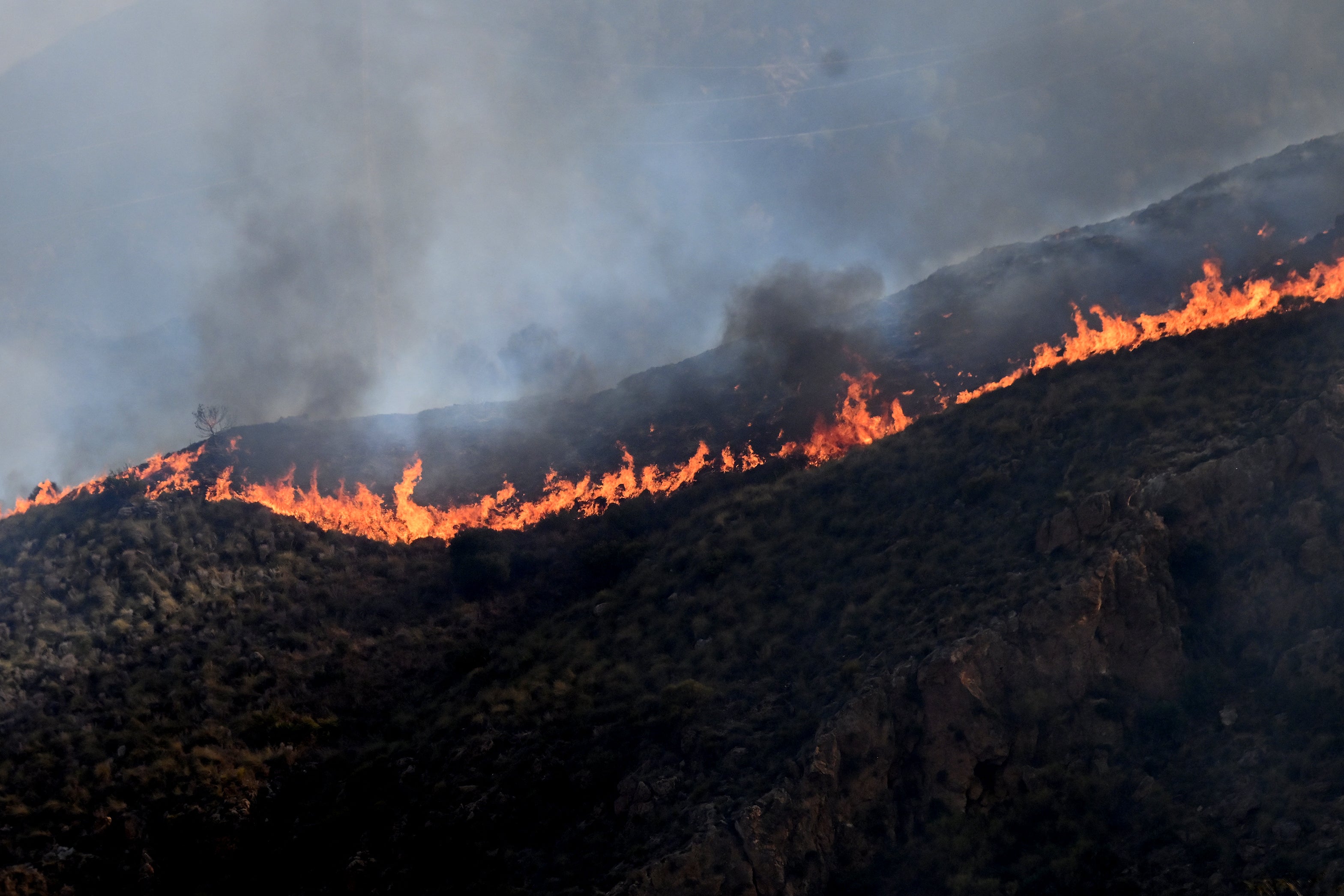 Flames burn on a hillside during a wildfire near Bedar (AFP/Getty)