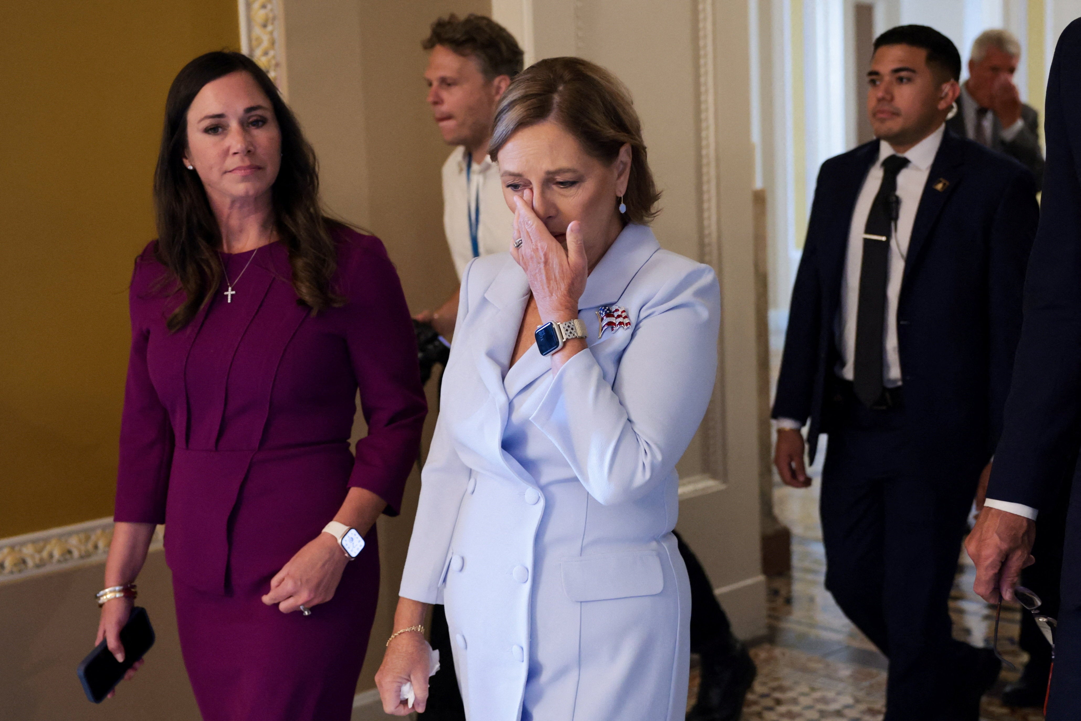 Darline Graham, sister of late Sen. Lindsey Graham wipes away tears as she leaves the Senate floor after visiting her late brother's desk, before her swearing-in to fill his seat Tuesday.